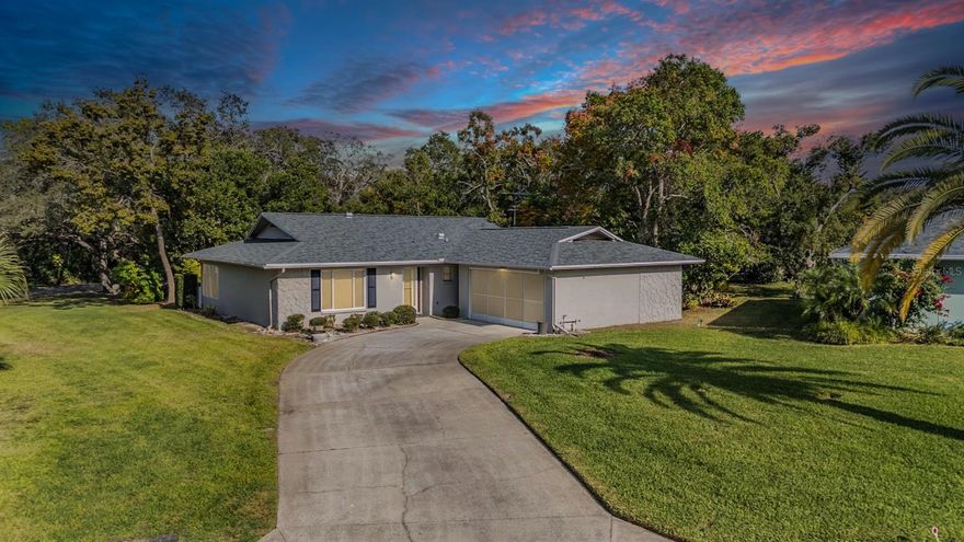 Discover the perfect blend of comfort, privacy, and effortless living in this beautifully updated home on a charming, oversized, pie-shaped lot.  A/C 2017, ROOF 2025, FRESHLY PAINTED INTERIOR, NEWER WINDOWS, NEW LVP FLOORS, UPDATED KITCHEN  The inviting patio—framed by a quaint picket fence and lush privacy hedge—is the ideal spot to begin or end your day. Inside, luxury vinyl flooring flows through the open living and dining areas, complemented by a soft, neutral palette and updated windows that fill the space with natural light. The sunroom impresses with wood-look tile and floor-to-ceiling windows that seamlessly connect to the outdoor patio. The fully updated kitchen shines with granite countertops, stainless steel appliances, an eat-in breakfast nook, and easy-care ceramic tile floors. An oversized walk-in laundry room with a utility sink adds convenience. Both bathrooms have been thoughtfully refreshed, including the master suite, which features abundant closet space and an updated bath with a walk-in shower and wood-look tile floors. Located in a low-HOA, 55+ community, residents enjoy a vibrant lakeside clubhouse with stunning views, a heated pool and spa, tennis and pickleball courts, shuffleboard, bocce, billiards, and an active social calendar. Sidewalk-lined streets invite peaceful evening strolls. Just minutes from medical facilities, pharmacies, grocery stores, restaurants, and everyday conveniences—plus world-class Gulf Coast beaches and Tampa/St. Pete airports under an hour away—this move-in-ready home offers the ultimate in easy, active, and enjoyable living. Don’t miss this opportunity to embrace a lifestyle of comfort, convenience, and community!