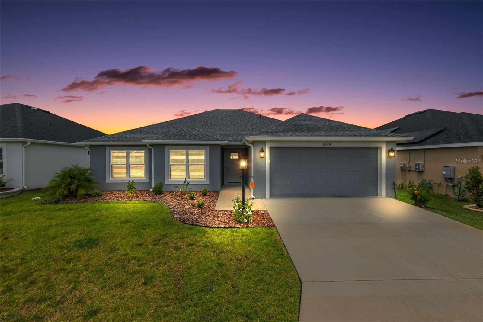 FABULOUS 3/2 BLOCK and STUCCO Designer Bluebird with REAR PRIVACY WALL in the highly sought after Village of Newell - JUST MINUTES from the popular Sawgrass Grove! Built in 2023, this nearly new home offers low-maintenance peace of mind with modern design! Step inside to discover a bright, OPEN-CONCEPT layout filled with NATURAL LIGHT, rich warm-toned LUXURY VINYL PLANK flooring, and stylish finishes throughout. The living and dining rooms feature HIGH ceilings creating a SPACIOUS and voluminous main living area. The AMAZING kitchen showcases GORGEOUS GRAY cabinetry with PULL-OUTS, QUARTZ countertops, built-in DOUBLE PANTRY, STAINLESS steel appliances, GLASS TILE backsplash, under-cabinet LIGHTING, a LARGE CENTER ISLAND with additional cabinetry and breakfast bar, and an ADJACENT DINETTE - ideal for casual everyday dining. DOUBLE sets of sliding glass doors, from the living room and dinette, invite you to enjoy true Florida living in the EXPANSIVE SCREENED-IN LANAI overlooking the SPACIOUS backyard with a rear PRIVACY WALL! This wonderful retreat offers plenty of room for lounging, dining, and year-round outdoor entertaining. It also features an adjacent rear patio - perfect for grilling! Whether sipping your morning coffee, hosting a weekend barbecue, or unwinding after a long day, this FANTASTIC space is your own private escape! Back inside, the luxurious primary bedroom boasts VAULTED ceilings, and a LARGE WALK-IN closet. Its en-suite bathroom features GRAY cabinetry, QUARTZ counters, DOUBLE vanities, TILED WALK-IN ROMAN shower, LINEN closet, and a separate water closet. The SPLIT floor plan offers two additional bedrooms and second bathroom located near the front of the home. Bedroom two and the second bathroom are conveniently hidden behind a POCKET door creating a PRIVATE GUEST WING and/or QUIET home office. Both bedrooms feature DOUBLE windows and built-in closets. Bathroom two boasts a GRAY vanity with QUARTZ countertop, TILED tub and shower combination, and a hallway LINEN closet. A centrally located INTERIOR laundry room features additional GRAY cabinetry, shelving, and a utility sink. Completing the package is a two-car garage with plenty of room for parking and extra STORAGE needs! DON'T MISS THE OPPORTUNITY TO MAKE THIS AMAZING HOME in a FANTASTIC LOCATION YOUR OWN! The Village of Newell is close to Sawgrass Grove, Brownwood Paddock Square, and the new upcoming Eastport Square; six neighborhood pools and recreation centers (Franklin, St. Catherine, Bradford, Aviary, Hawkins, Homestead); three large regional recreation complexes (Ezell, Everglades, and Rohan); Southern Oaks Country Club and Championship Golf Course; Clifton Cove Putting Course; Mickylee Pitch and Putt; shopping and dining at Magnolia Plaza; Homestead dog park for your furry friends and more! PLEASE WATCH OUR WALKTHROUGH VIDEO OF THIS FABULOUS HOME and call today to schedule your Private Showing or Virtual Tour!