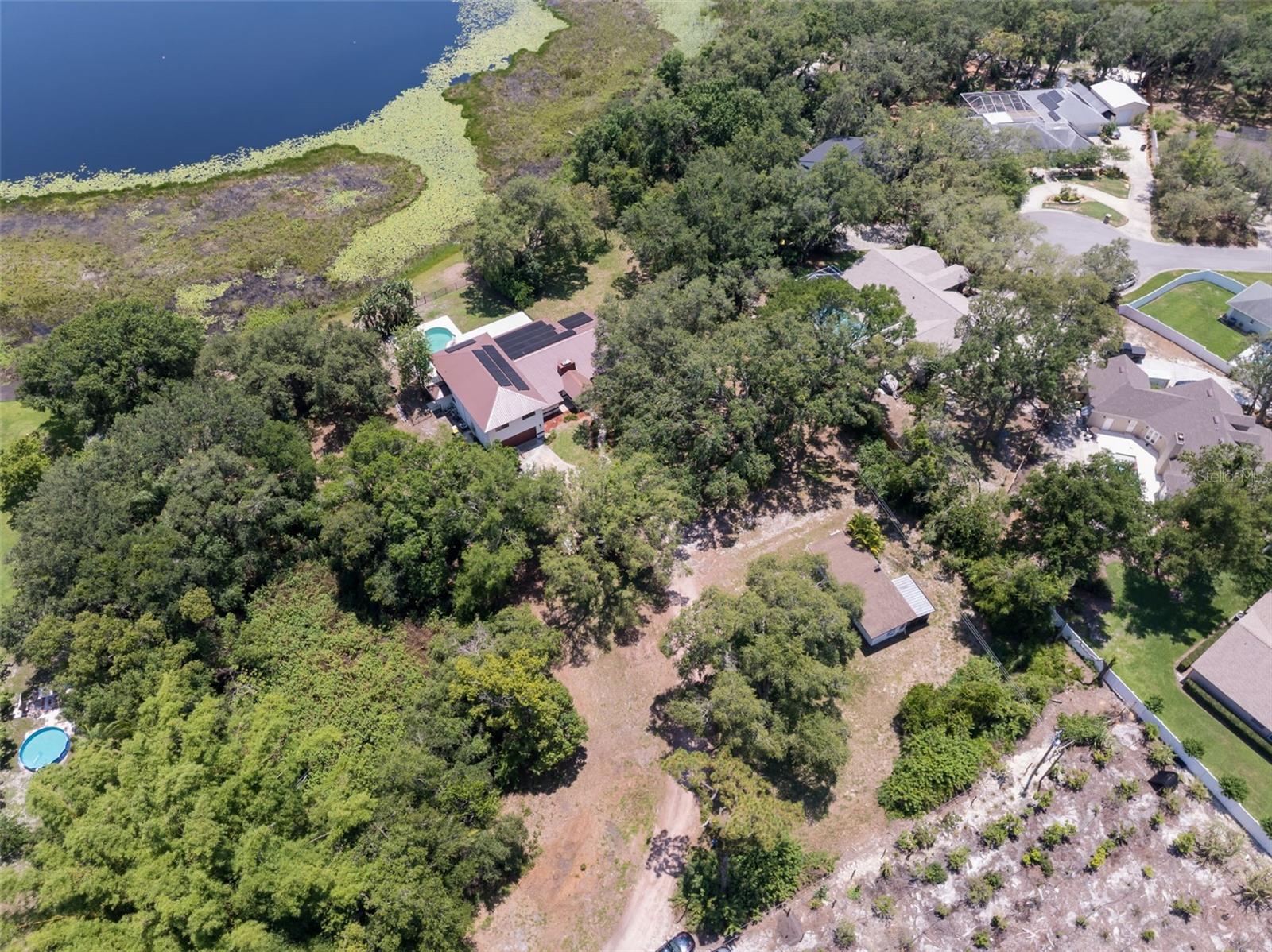 Experience luxurious lakefront living with unmatched privacy and modern upgrades at 5671 Cypress Gardens Road in Winter Haven, FL. Situated on 4.53 serene acres with stunning lake frontage, this expansive estate features just over 4,300 total living square feet, including a beautifully remodeled main residence and guest house.
Step inside to find a completely remodeled kitchen, thoughtfully redesigned with modern finishes and functionality in mind. The master bedroom and bathrooms have been fully renovated, featuring all-new flooring that flows throughout the home, creating a cohesive and elegant living space.
Major updates include a brand-new roof installed in 2024, a new septic tank (2023), and a new well (2023)—ensuring peace of mind for years to come. Plus, the property is equipped with solar panels that will be paid off at closing, allowing the future owner to enjoy virtually no electric bills for life!
The spacious layout includes 6 bedrooms and 6 bathrooms, perfect for multi-generational living, a large family, or entertaining guests. The guest house has been completely renovated, offering added comfort, flexibility, and privacy.
Enjoy outdoor living with a 12x24 private pool, barn, and panoramic lake views—ideal for relaxing, fishing, or hosting unforgettable gatherings. Located just minutes from Legoland, Hwy 27, top-rated schools, shopping, and dining, this property offers both convenience and tranquility.
Don’t miss the opportunity to own this beautifully updated lakeside estate—where comfort, efficiency, and elegance meet.