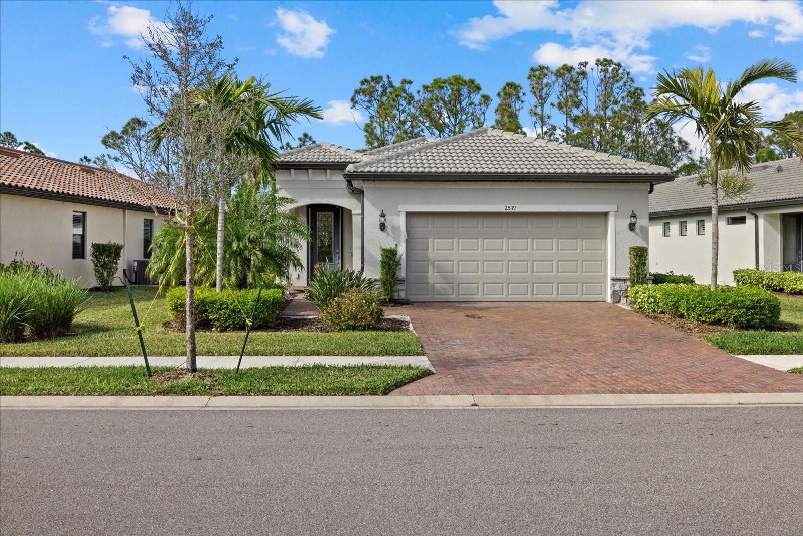 BUILT IN 2021. HURRICANE PROTECTION. FURNISHED. Welcome to this stunning, move-in-ready 3-bedroom, 2-bathroom home, built in 2021, located in the desirable 55+ Cypress Falls gated community in North Port, FL. UPGRADES include LeafFilter gutter guards, ACCORDION HURRICANE SHUTTERS on all windows, and POWER ROLL-DOWN shutters on the front door and lanai, offering ultimate storm protection and easy maintenance. This meticulously maintained property offers modern convenience and peace of mind with numerous upgrades designed for comfort and security. Step inside and enjoy the spacious, open floor plan with a bright and airy living space. The kitchen, with stainless steel appliances and quartz countertops, features a REVERSE OSMOSIS system at the sink for pristine drinking water. There are also extra kitchen cabinets showcasing a handmade bar-top with Monkey Pod Wood from Costa Rica along with an extra beverage fridge. The spacious primary bedroom, located to the rear of the home, highlights a generous primary bathroom with dual sinks, large walk-in shower, private water closet, linen closet and large walk-in closet. Two guest bedrooms provide plenty of room for guests to stay and still have a room for an office or crafts. The screened lanai and pull-down GARAGE SCREEN provide seamless indoor-outdoor living for enjoying the beautiful Florida fresh air. The garage is complete with an extra 4 foot extension to give you extra space as well as built in storage shelves. This home is being sold furnished. For added convenience, this home includes a GENERATOR with a transfer switch, ensuring you're prepared for any weather. Situated in the highly sought-after Cypress Falls 55+ community, you'll enjoy a low-maintenance lifestyle with a large clubhouse with resort-style amenities to include a community pool, resistance pool, tennis and pickleball courts, bocce ball, meeting rooms, library, Billard’s room, fitness center, dog park and MANY community clubs and classes to join to meet and make new friends. GOLF CART friendly community! Don't miss your chance to live in this vibrant, active adult community with easy access to I-75. Schedule your showing today! Please copy and paste the following into your browser in order to watch a luxury video tour of 2539 Brassica Dr: https://sites.hdmediahouse.com/2539-Brassica-Dr/idx