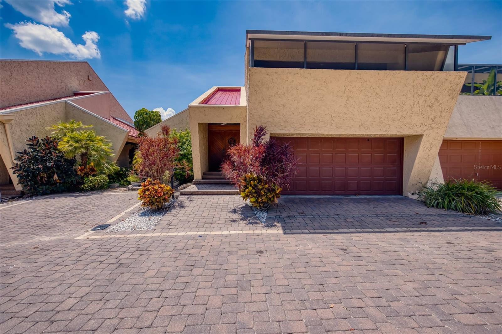 Discover a rare opportunity to own this architecturally distinctive 2-bedroom, 2.5-bath residence located in the gated community of Casarean on the Lakes. This well-designed home offers an impressive blend of indoor and outdoor living spaces. The main level features a formal living room with a fireplace and wet bar, a dining area, a functional kitchen with breakfast bar, a guest half bath, and two private outdoor living areas. An attached one-car garage provides added convenience. Upstairs, you’ll find two spacious bedroom suites each with a private en-suite bath, as well as a versatile loft area. Step out to the screened balcony or the open upper deck, perfect for enjoying tranquil lake views and evening breezes. Community amenities include a swimming pool with spa, tennis court, lakeside dock, beach area, and a gated entry with electronic access. Whether you're seeking a seasonal retreat or a full-time residence, this unique property offers comfort, style, and a desirable location.