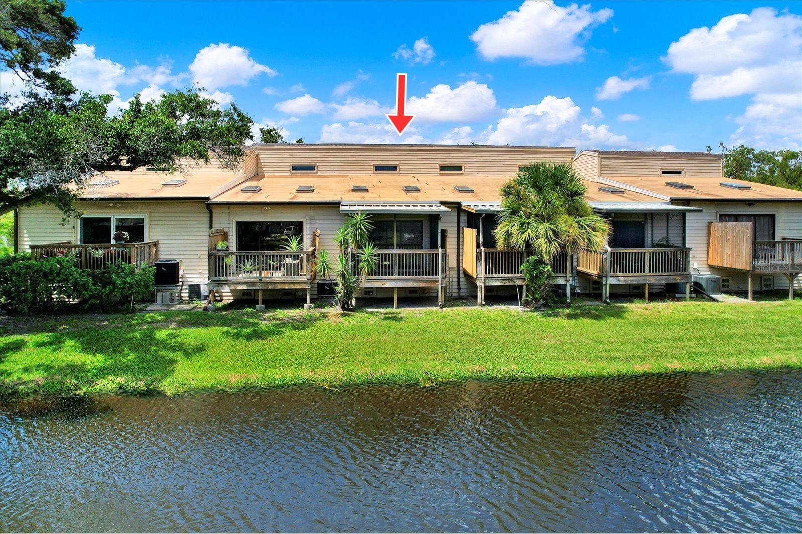 One or more photo(s) has been virtually staged. Welcome to this charming home with two spacious bedrooms, two bathrooms, a rare ONE CAR GARAGE and a beautiful WATER/POND VIEW. As you enter, you'll be greeted with an UPDATED KITCHEN adorned with elegant GRANITE COUNTERTOPS, newer cabinetry and stainless steel appliances. The OPEN CONCEPT kitchen flows seamlessly into the dining and living areas. The HIGH CEILINGS and SKYLIGHTS create a bright and airy atmosphere, making it an ideal space for entertaining or relaxing.
Step outside onto the SCREENED PATIO, where you can enjoy tranquil VIEWS OF THE POND and its lovely fountain. This outdoor space is perfect for sipping your morning coffee or unwinding after a long day. The convenience of a ONE-CAR GARAGE leads to an additional spacious room that houses an INDOOR LAUNDRY closet with washer and dryer hookups. The private front entrance has a lockable decorative metal/screen door with a covered hall leading to the front door.
Have the peace of mind with a NEWER ROOF (2023) and the entire house has been RE-PLUMBED removing all of the polybutylene pipes! The Hot water tank is 2020, HVAC 2016. Lake Forest Community residents and their guests can enjoy the serene pond with boardwalk and an expansive POOL and HOT TUB with the convenience of onsite restrooms, picnic table, grill and plenty of seating to enjoy the beautiful FL weather. The HOA FEE covers maintenance of the community POOL and HOT TUB as well as grounds maintenance, CABLE TV, INTERNET, WATER, SEWER, and TRASH services, making this an EXCEPTIONAL VALUE!!! Bring your furry friends to this PET FRIENDLY community. This is a Flood zone X property that did not sustain any issues from the hurricanes. Lake Forrest community has plenty of guest parking and is CENTRALLY LOCATED to all that Pinellas County has to offer including being only 10 miles from Florida’s beautiful BEACHES and 11 miles from Downtown St. Petersburg!! A short 6 miles from St. Pete/Clearwater AIRPORT. The community is also located across the street from the Forbes Recreation Center that offers a plethora of activities. Don’t miss the chance to call this wonderful condominium your home!