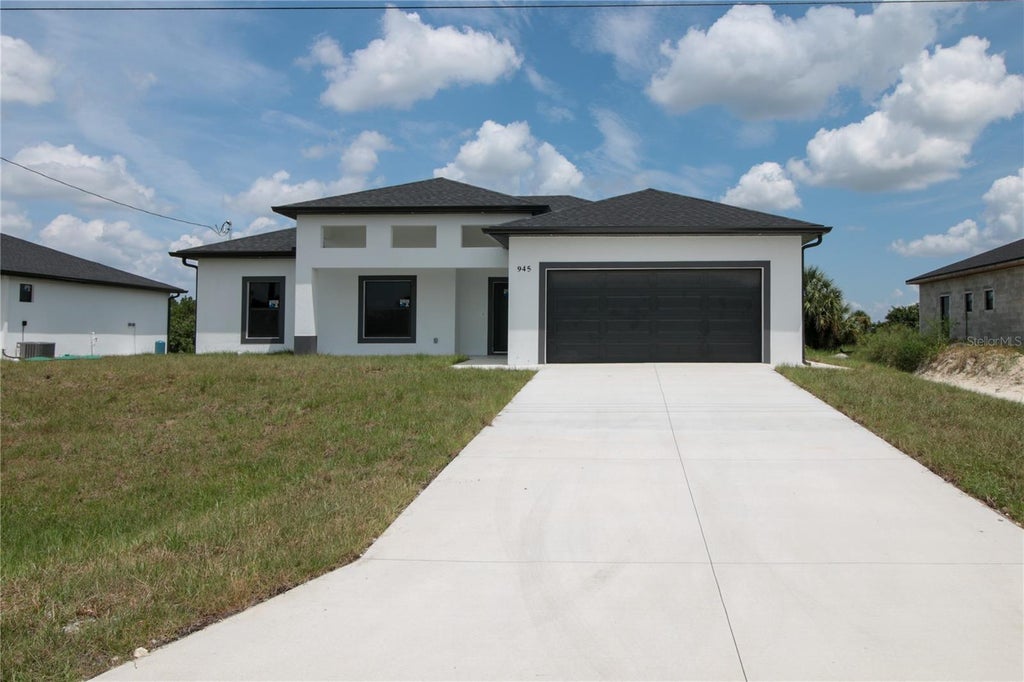 Photo of 945 Commodore Street, Lehigh Acres, FL 33974 (MLS # O6438060)