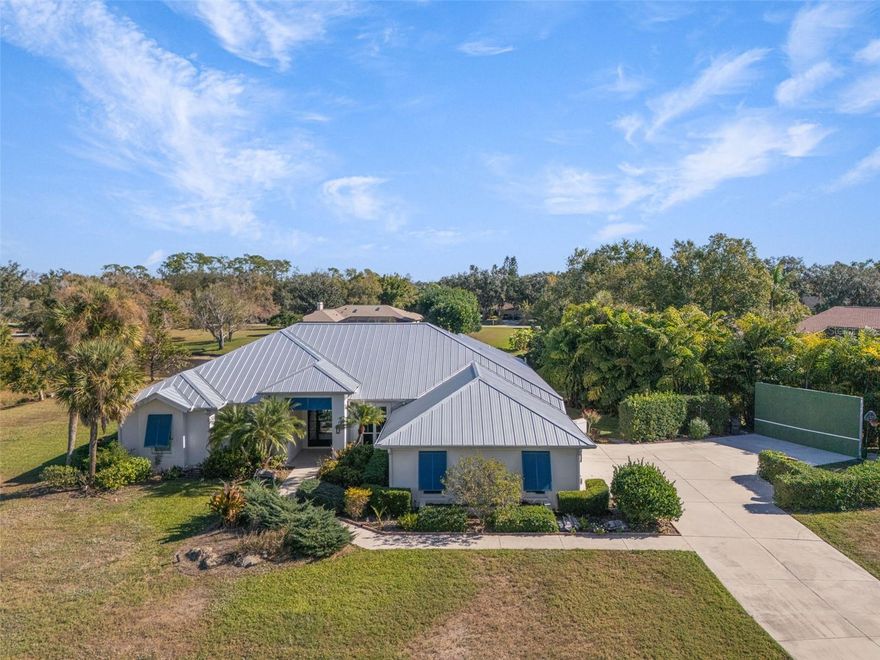 One or more photo(s) has been virtually staged. Set on 1.1 private acres with peaceful lake views in the deed-restricted Country Creek community, this 3-bedroom, 3-bath Sarasota home offers a rare combination of space, privacy, flexibility, and long-term potential that is increasingly difficult to find. Recent pricing adjustments also create additional flexibility for buyers who may wish to personalize select finishes, enhancements, or future improvements over time, allowing the next owner to tailor the property to their own vision while securing one of the larger and more adaptable homesites currently available in Sarasota.

Inside, the 2,962 sq ft floor plan features high and vaulted ceilings, abundant natural light, ceramic tile throughout, a split-bedroom layout, a large private office, and a separate den ideal for remote work, guests, or multi-generational living. The kitchen is anchored by full quartz slab countertops, an oversized custom quartz island, and soft-close cabinetry designed for both everyday living and entertaining.

Every window has been upgraded to impact-rated, insulated, low-E glass, while a 2021 metal roof and hurricane-grade front entrance provide meaningful storm protection and potential insurance savings. The 1.1-acre lot also allows for construction of an attached ADU and attached garage addition, creating exceptional flexibility for buyers seeking rental income potential, future expansion, or long-term multigenerational living. Fencing is permitted across the full property for added privacy, pets, or recreation.

Outside, a screened in-ground pool, generous outdoor living areas, mature landscaping, three-car garage, and extended driveway provide functionality without sacrificing privacy or usable space. Conveniently located near Siesta Key Beach, downtown Sarasota, Sarasota-Bradenton International Airport, top-rated schools, and I-75 access, this is a property designed to evolve with its owner for years to come.