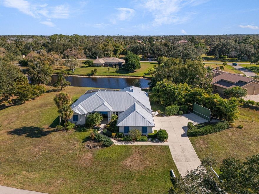 RECENTLY IMPROVED PRICE!! Set on 1.1 private acres with lake views in the quiet, deed-restricted Country Creek community, this 3-bedroom, 3-bath, 2,962 SF residence offers the space and comfort ideal for family living and hosting. The open floor plan with high and vaulted ceilings throughout creates a bright, expansive atmosphere, while the split bedroom layout, large office, and separate den provide privacy and flexibility for a growing family or multi-generational needs. All windows throughout the home have been upgraded to impact-rated, insulated, low-E windows. Ceramic tile flows throughout the home, and the kitchen serves as a natural gathering place with full quartz slab countertops, a custom oversized quartz island, and soft-close cabinetry and drawers, perfect for everyday life and holiday entertaining. The home’s scale lends itself beautifully to seasonal décor and large gatherings, with a screened pool and generous outdoor space extending the living experience. A three-car garage and extended driveway easily accommodate multiple vehicles and guests, while a metal roof installed in 2021, hurricane-grade front entrance, and thoughtfully landscaped side yard with unique plantings add peace of mind, privacy, and character. This is a home designed to grow into, celebrate in, and make lasting memories, all just minutes from Sarasota’s beaches, dining, and shopping.