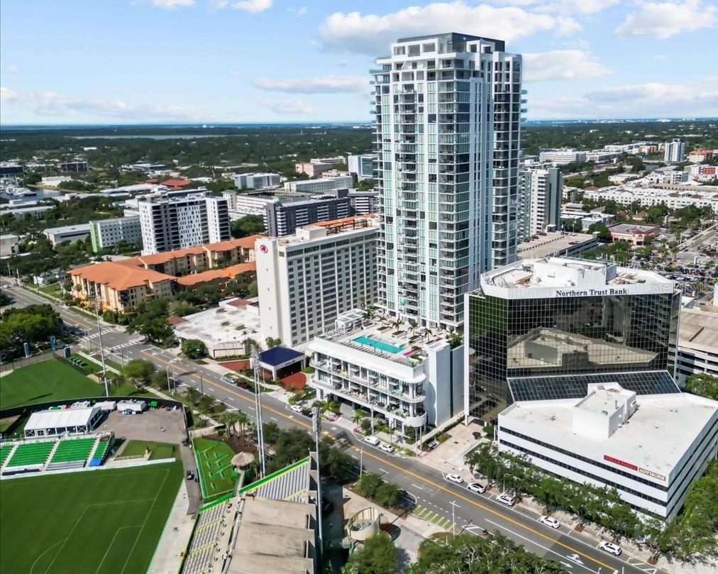 CONDO IS FULLY FURNISHED AND TURN KEY! Experience elevated living in Saltaire, St. Pete’s newest redefined luxury high-rise located in the heart of vibrant Downtown. This open-concept, split floor plan condo offers nearly 2,100 sq ft of refined living space, featuring 2 bedrooms + a versatile bonus room that can easily serve as a 3rd bedroom, home office, or den, and 3 full bathrooms. Step into a space that exudes sophistication—FULLY FURNISHED with high-end pieces from Restoration Hardware, Crate & Barrel, and other premium brands. The gourmet kitchen is a chef’s dream with top-of-the-line appliances, quartz countertops, a spacious island with breakfast bar, abundant storage, and even a built-in dry bar for entertaining. Enjoy two private terraces—one facing northeast and the other northwest—perfect for taking in partial bay and marina views, as well as breathtaking sunrises and sunsets. The Primary Suite offers direct access to the northeast-facing terrace, two walk-in closets, and a spa-inspired en suite bath complete with dual sinks, quartz countertops, a soaking tub, large walk-in shower with built-in bench, and a private water closet. The second bedroom is generous in size with its own private en suite and balcony access. High ceilings and an abundance of natural light flow throughout the unit, enhancing the feeling of luxury and space. Saltaire’s resort-style amenities rival any five-star retreat: a rooftop pool/spa with cabanas, three outdoor kitchens/BBQ areas with stunning views of the marina and Al Lang Stadium (home of the Tampa Bay Rowdies), a state-of-the-art fitness center, stylish clubhouse with dining area and full kitchen for hosting, a coffee bar, 24-hour security, and more! Located just steps from renowned landmarks like the Salvador Dalí Museum, Mahaffey Theater, St. Pete Pier, and countless fine dining, rooftop bars, parks, marinas, and retail, Saltaire offers an unmatched urban lifestyle with Gulf access just beyond your door. This unit comes with assigned parking, and embodies luxury, low-maintenance living where elegance meets modern convenience and comfort.
