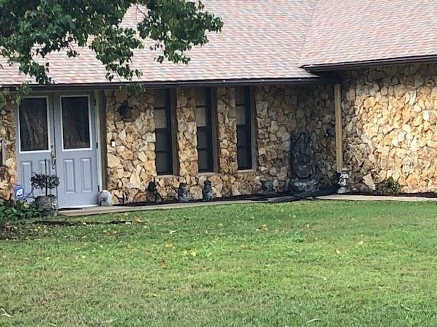 Come for a Visit ~ Stay for a Lifetime! Spacious Country Pool Home on 1.24 Acres! Surrounded by meticulously maintained grounds, this home offers an abundance of custom features - a private, relaxing & enjoyable lifestyle in a Beautiful Country Setting! Custom designed with a “Mexican Flair”, this Roomy Pool Home has 3BR’s, 3 Baths & an Oversized 2-Car Garage (24'x32'). Sprawling 1.24 Acre Lot, w/Additional Driveway, has ample room for RV/Boat Parking. Zoned A-3 (horses permitted). Welcome to Paradise! Sturdy Concrete Block Construction w/Beautiful Coquina Stone Accent & NO HOA FEES in the East Wind Estate Community! “Unique” Mexican Tile throughout, a NEW Roof (December 2020) & complete protection provided by the Audio/Video Surveillance System! Double Door, Etched Glass, Front Entrance leads directly to the Living Room, separated from the Family Room by a Double-Sided Coquina Stone Fireplace! The Kitchen features NEW Black Stainless Steel Appliances & a Pass-Thru to the Dining Room. French Doors provide direct access to the Pavered, Covered Lanai from the Family Room, Dining Room & Master Suite. Custom Light Fixtures, & Ceiling Fans are featured throughout. The Newly Screened, Pavered Pool Area offers a Large, Extremely Private, Crystal Clear Inground Pool (16’x33’) & overlooks the Expansive Backyard. The fabulously functional floor plan ~ combined with the gorgeous pool area & sprawling grounds, makes this home Perfect for Entertaining! “Let the Party Begin!” The Oversized Garage (3-Car parking possible) has ample storage, attic access & a Full Screen Door. Landscaping, Plants & Mature Trees grace this Country Estate. A Tranquil Natural Estuary w/Private Wooded Views. Additional features include a Front Fountain & Lantern Post Light, a Garden, & a Utility Room (exterior access) used for pool equipment storage & the Water Treatment System. Bring your boat, RV, pets, kids and even your mom & dad! There's Plenty of Room for everyone and everything you love!