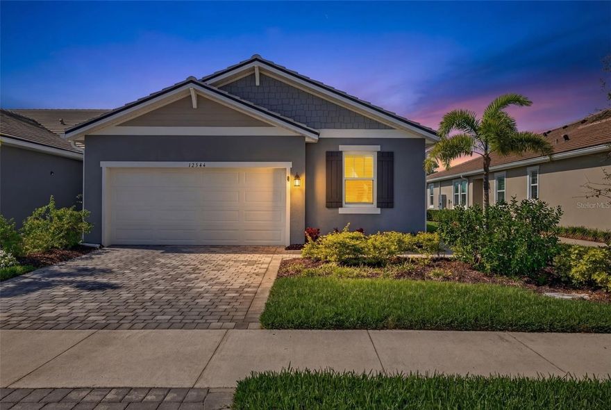You won't want to miss this one! This highly upgraded three-bedroom, two-bath plus den villa is tucked away on a quiet cul-de-sac street in the beautiful Sunstone community within the vibrant Wellen Park. This stunning home showcases exceptional craftsmanship and extensive custom upgrades throughout. Step inside to discover an elegant, open-concept floor plan enhanced by crown molding, stylish light fixtures, and beautiful custom details throughout. The chef-inspired kitchen features quartz countertops, premium stainless-steel appliances, a tile backsplash that extends to the ceiling, a custom-designed pantry, and an oversized island with seating for four. The private den, designed as a sophisticated home office, features double glass doors, custom wood cabinetry, and beautiful granite countertops, offering exceptional storage and style. Entertaining is effortless and is complemented by a custom-built-in bar featuring solid-wood cabinetry, a wine rack, and glass display cabinets, perfect for showcasing glassware and creating a true focal point for gatherings. The great room is impressively spacious, seamlessly flowing into the dining area for effortless entertaining. Designed to embrace the Florida lifestyle, this space features built-in wood cabinetry with a beautiful granite countertop that is both functional and elegant, leading directly to the lanai through triple-impact-glass sliders framed by rich custom woodwork, creating a stunning architectural focal point and adding warmth and character to the home. Enjoy sunsets on your private lanai, which features a beautiful wood ceiling and crown molding to match. The primary suite features a tray ceiling, a shiplap accent wall, and a luxurious ensuite bathroom with a large walk-in shower, decorative woodwork, and a linen closet with built-in shelving for added storage. The walk-in closet offers built-in drawers and shelving, making it easy to stay organized. The guest accommodations are equally impressive, featuring one bedroom with a custom-designed shiplap accent wall, along with a guest bathroom appointed with quartz countertops, decorative woodwork, and new fixtures. The third bedroom has been freshly painted and, along with the additional guest bedroom, offers newer, upgraded carpeting for added comfort and style. Both the guest and primary bathrooms feature additional cabinetry for enhanced storage, and all closets throughout the home have been upgraded by Closets by Design. Even the laundry room has been upgraded with extended tilework, wood accents, countertop, and cabinetry stacked to the ceiling for maximum storage and convenience. The two-car garage features epoxy flooring, ceiling-mounted storage racks, additional cabinetry, and an air conditioning unit to keep the space cool and comfortable year-round. This one-of-a-kind home also includes impact glass on the front window, motorized storm shutters for additional protection on the additional windows, and plantation shutters throughout, providing both beauty and peace of mind. Located just minutes from the downtown Wellen Park, residents enjoy easy access to waterfront dining, boutique shopping, live music, farmers markets, scenic walking trails, and year-round community events centered around the Grand Lake. This luxury villa, with a peaceful cul-de-sac location and proximity to world-class beaches, is a rare opportunity to enjoy a beautifully enhanced home in one of Southwest Florida’s most exciting communities.