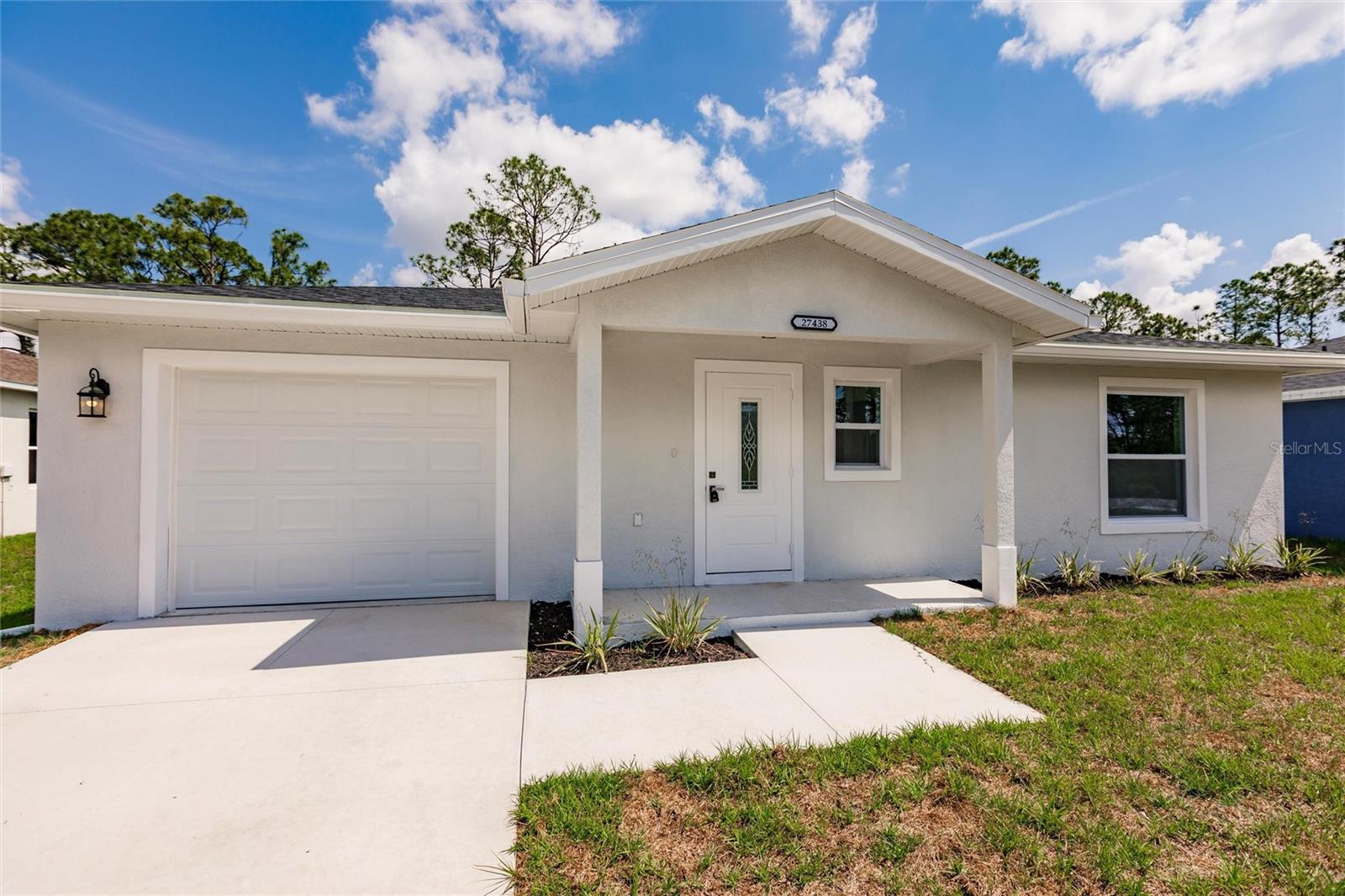 Under Construction. Skip the stress of building and move right into this brand-new 2-bedroom, 1-and-a-half-bathroom home with an attached garage, nestled in the peaceful rural community of Tropical Gulf Acres. Featuring an open-concept layout with a spacious great room, this home offers versatile living and entertaining space. Interior highlights include elegant wood-look luxury vinyl flooring throughout, tray ceilings in both the great room and primary bedroom, stylish light and ceiling fan fixtures, and recessed lighting for a modern touch. The kitchen is a standout with granite countertops, an abundance of shaker style cabinets, stainless steel appliances, a pantry, built-in buffet, and a breakfast bar that flows seamlessly into the great room—perfect for entertaining guests. The primary suite includes a built-in closet and a private full bath with a granite-topped vanity and linen storage. The guest bedroom also features a built-in closet. Additionally, a half bath in the hall adds to the practicality of the home. The property is further complemented by a single-car garage with ample space and a designated laundry area, providing the perfect combination of functionality and convenience. Hurricane impact windows throughout, provide enhanced storm protection, energy efficiency, and peace of mind year-round. Whether you're enjoying a quiet evening on the patio or entertaining friends in the open and inviting living space, this home is a haven of comfort and style. With its modern amenities, quality finishes, and the charm of being a single-owner property, this residence is ready to welcome its next chapter of memories. Located in a quiet, family-oriented neighborhood with no HOA or CDD. Minutes from historic downtown Punta Gorda, Fisherman's Village Restaurants, shopping, waterfront parks, events, and more. Close to I-75 and US-41. Near two airports: Punta Gorda and Southwest Florida International. Tropical Gulf Acres has a country-like feel, yet in a reasonable commute to Port Charlotte, Fort Myers, or Cape Coral.