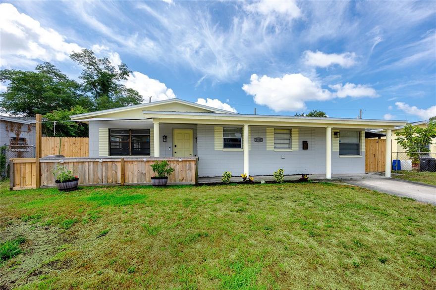 This Pinellas Park home checks the boxes most buyers are searching for: solid block construction, a brand new roof, no flood zone, and the flexibility of no minimum rental terms or an HOA. Fresh cedar fencing and a wide covered front porch make for a welcoming first impression on well maintained and updated property that works equally well as a primary residence or a straightforward income play.
Inside, the open living and dining space flows into a kitchen with solid wood cabinetry, black granite countertops, a tiled backsplash, and stainless appliances that offer genuine workspace without the galley feel. A dedicated interior laundry room with built-in storage sits just off the kitchen, a practical detail that larger homes take for granted and smaller ones rarely have. On the secondary side of the split layout, two bedrooms and a private office or flex room share a full bath with an updated vanity and rain showerhead, a configuration that translates well whether the household needs a home office, guest quarters, or a tenant-ready wing.
The primary suite occupies its own end of the home, separated from the rest of the house by a vaulted-ceiling bonus room that earns its place as a studio, sitting room, or playroom depending on who's living here. The primary bedroom is king-sized, connecting to a private en-suite bath with a tub-and-shower combination and updated vanity. With the bonus room and primary wing positioned the way they are, a self-contained mother-in-law suite with private exterior access is a realistic conversion with minimal modification.
The backyard is fully fenced with a fire pit and room to actually use the space. Along the side of the property, a covered run with a corrugated metal roof handles tools, bikes, and gear cleanly. Loyd Tingler Park is just blocks away, and Mainlands Golf Course, Bardmoor Golf & Tennis Club, and several horse stables are just minutes away, offering a variety of outdoor activities in your backyard. St. Pete-Clearwater International Airport, the Gulf beaches, and downtown St. Petersburg are all a short drive from central Pinellas, keeping you connected to the best amenities of Pinellas County.