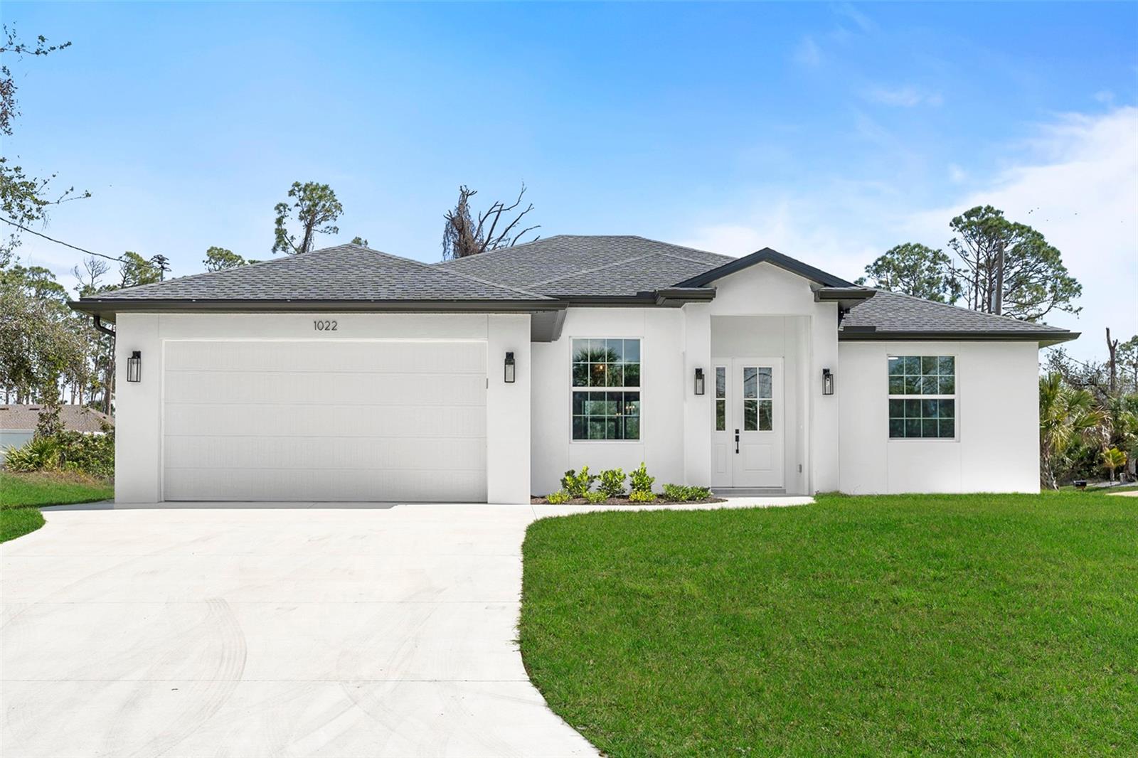 Welcome to this LUXURIOUS, MODERN, GORGEOUS, TRULY UNIQUE CUSTOM BUILT HOUSE with high ceilings throughout with 3 bedroom, 2 bathroom plus an office. The home is located in PRIME location of North Port on an over-sized corner lot. The home features a bright open floor plan providing an inviting and modern feel as soon as you step inside, which makes it perfect for both entertaining and relaxing. The kitchen features a high end appliance package, quartz countertops with backsplash, breakfast bar, and tall cabinets with soft close cabinet drawers and doors. The large living room includes a stunning Spanish porcelain tile, creating a cozy and inviting atmosphere. Both bathrooms feature custom tile work, quartz countertops and spacious all tiled showers. This house has many upgrades like WHOLE HOUSE REVERSE OSMOSIS SYSTEM, CUSTOM BUILT WOOD SHELVES IN PANTRY AND BEDROOM CLOSETS, IRRIGATION SUSTEM, hurricane resistant windows and doors, epoxy garage floor, side walk all the way around the house, complete gutter package, laundry rooms comes with utility sink, extra wide driveway and lanai, culvert pipe complete covered drainage system. The upgrades go on and on!!! Located in a great area with easy access to local amenities and attractions, US 41, beaches, shopping, restaurants, fishing, Cool Today Park, Wellen park, North Port Aquatic Center, and major interstate access nearby, this home truly has it all. Don't miss out on the opportunity to make it yours. Call today for your private showing!