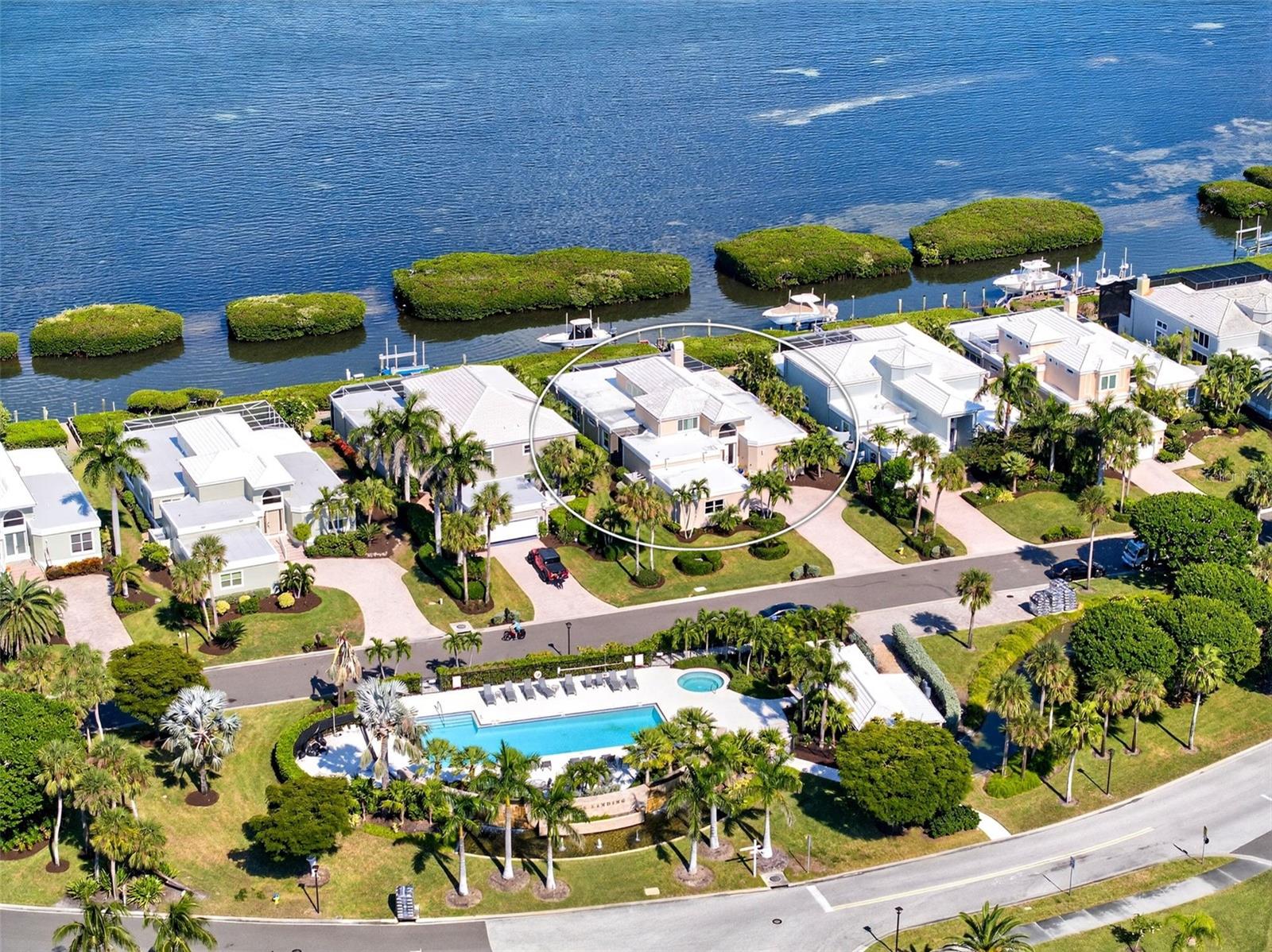 A Rare Longboat Key Bayfront Opportunity. Discover an exceptional opportunity to live behind the gates of the Longboat Key Club in the highly coveted Corey’s Landing neighborhood — one of the island’s premier bayfront addresses. Rarely available, this detached single-family home offers direct Sarasota Bay views, a private boat dock and lift, pool, three bedrooms plus a study, a loft, and three-and-a-half baths. Set within an intimate, established community of just 61 single-family homes and villas, this residence welcomes you through double doors into a showplace of light, style, and space. Soaring transom windows, walls of sliding glass, and rich wood floors enhance the open great-room design — an ideal setting for entertaining around the beautiful fireplace. The updated kitchen connects seamlessly to the dining and living areas, featuring sleek white cabinetry, a striking tile backsplash, solid-surface countertops, stainless steel appliances, and a generous breakfast bar perfect for casual gatherings. The first-floor master suite is a private retreat with walls of glass, a cozy sitting area, custom built-ins, dual closets, and a luxurious remodeled bath with dual vanities, a large walk-in shower, and separate water closet. Also on the main level are two private guest suites, a study/den, and even a convenient outdoor dog space. Upstairs, a versatile loft offers space for a gym, library, or extra guest accommodations. Step outside to the expansive screened lanai — an inviting oasis for relaxing or entertaining by the pool while enjoying mesmerizing bay views and the glittering lights of downtown Sarasota. Two car attached garage provides plenty of storage space. Corey’s Landing residents enjoy access to a community pool, spa, Har-Tru tennis courts, and the private Bay Isles Beach Club. Ideally located near shopping, dining, and the world-renowned St. Armands Circle, this home represents the ultimate Longboat Key lifestyle — elegant, relaxed, and effortlessly connected to both land and sea.