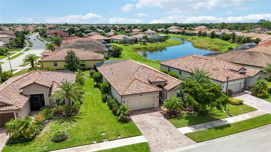 Live like you're on vacation every day! Built in 2016, this 4-bedroom, 3-bath Trevi floor plan offers 2,025 square feet of thoughtfully designed living space, featuring a CUSTOM HEATED SALT WATER POOL/SPA with breathtaking lake and sunset views—all nestled within the resort-style, gated community of Gran Paradiso. NOT IN A FLOOD ZONE. 

With a practical split floor plan, this home offers a warm and inviting layout ideal for everyday living and entertaining. Three of the bedrooms are located at the front of the home, including a true guest suite with its own private ensuite bath, perfect for visitors or multigenerational living. The other two bedrooms share a nearby full bath off the hall. The spacious primary suite is tucked at the back of the home for added privacy and features pool and lake views, two large walk-in closets, and an ensuite bath with a soaking tub, walk-in shower, and dual vanities.
You'll also find porcelain wood-like plank tile flooring and crown molding in the main living areas. The kitchen is the heart of the home, offering a generous island with bar seating, granite countertops, stainless steel LG appliances, a walk-in pantry, and a whole-house water filtration system—providing clean, high-quality water throughout.

Upgraded outdoor living is a must in Florida, so step outside to your private screened-in lanai with a sparkling CUSTOM HEATED SALT WATER POOL AND SPA, where you can enjoy serene lake views and breathtaking sunsets year-round. Located on a quiet street within a gated community, this home is ideal for full-time residents or seasonal enjoyment.

Gran Paradiso offers world-class amenities designed to elevate your everyday lifestyle. Whether you're enjoying a refreshing swim or a family movie night by the massive resort-style pool and spa, staying active in the state-of-the-art fitness center, playing a game of tennis or pickleball or  gathering in the elegant clubhouse, there's something for everyone. The neighborhood is known for its friendly atmosphere, lush landscaping, and scenic sidewalks that wind through the community and around serene lakes—perfect for walking, jogging, or simply taking in the view.

The HOA includes cable TV, lawn maintenance, and access to all community amenities—making luxury living effortless.
All of this is just minutes from vibrant Downtown Wellen Park, where you can enjoy dining, shopping, and weekly events, and less than 10 miles from the pristine Gulf Coast beaches.  Schedule your private showing today and discover why Gran Paradiso is one of Venice’s premier lifestyle communities.