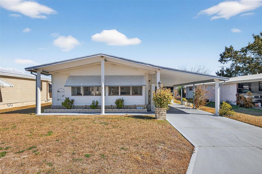 COLONY HILLS – MOVE-IN READY 2 BEDROOM, 2 BATH HOME WITH NO LOT RENT!
You own the land under this home — such valuable benefit! Step into a bright and spacious living area filled with natural light from the many windows, featuring upgraded and updated flooring throughout. Just off the living room, you’ll find a well-appointed kitchen with ample cabinet space and a convenient breakfast bar, perfect for casual dining or conversation while cooking. The adjoining dining area includes a beautiful built-in china cabinet, making this space ideal for entertaining family and friends. The master bedroom is privately located at the back of the home and offers an en-suite bath with a walk-in shower and a large vanity area. The guest bedroom and second bathroom provide a comfortable and welcoming space for visitors. Enjoy the convenience of an interior laundry room — no need to go outside or navigate stairs. Just off the laundry area is a Florida room, providing additional living or relaxation space, along with a nicely sized shed in the rear for extra storage, tools, or belongings. Additional features and upgrades include a wheelchair lift, water filtration system, newer AC system, and updated plumbing. This well-maintained home is truly move-in ready and perfect for Florida living — don’t miss this opportunity! Colony Hills is a vibrant 55+ community offering a recreation center, pool, shuffleboard, tennis courts, and a calendar full of activities. Ideally located just off Highway 54 West, you’ll enjoy easy access to Wesley Chapel, Tampa, Dade City, and Gulf Coast beaches.