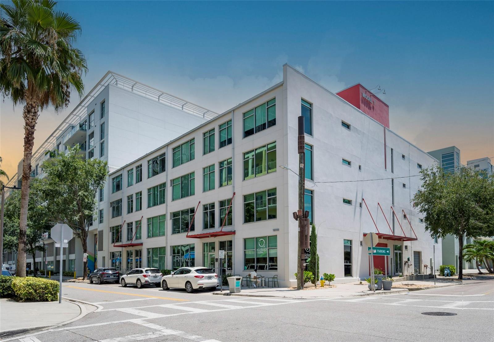Tucked inside one of Tampa’s most unique and storied buildings, Unit 306 at Victory Lofts offers an authentic urban living experience in the heart of the Channel District. Originally built in the 1920s as an auto storage facility, the Model T Building has been thoughtfully converted into industrial-style lofts that reflect the area’s rich history while offering modern-day comfort.
This spacious one-bedroom, one-bath condo combines exposed concrete details, soaring ceilings, and expansive windows that fill the space with natural light. The kitchen is both functional and stylish, featuring granite countertops, a gas range, stainless steel appliances, a French door refrigerator, and a sleek tile backsplash. A custom barn door creates separation for the primary suite, full bathroom, and in-unit laundry closet. For added versatility, a built-in Murphy bed allows for additional sleeping space when needed.
Additional highlights include a new A/C system, a dedicated garage parking spot behind the building’s secure gated entrance, and a separate storage unit.
Victory Lofts residents enjoy a variety of community amenities including a rooftop deck with skyline views, a well-equipped fitness center, a dog run, a media lounge, and a renovated club room. The monthly HOA covers water, sewer, trash, gas, cable, and internet—making for a convenient and cost-efficient lifestyle. The building has also recently undergone a full roof replacement.
The location couldn’t be better—just blocks from Amalie Arena, Sparkman Wharf, Water Street, and the Riverwalk, with easy access to dining, coffee shops, and public transportation. Street parking permits are also available for residents on 12th Street.
Unit 306 offers a rare opportunity to own a piece of Tampa’s architectural past with all the advantages of modern downtown living. Easy to see anytime!