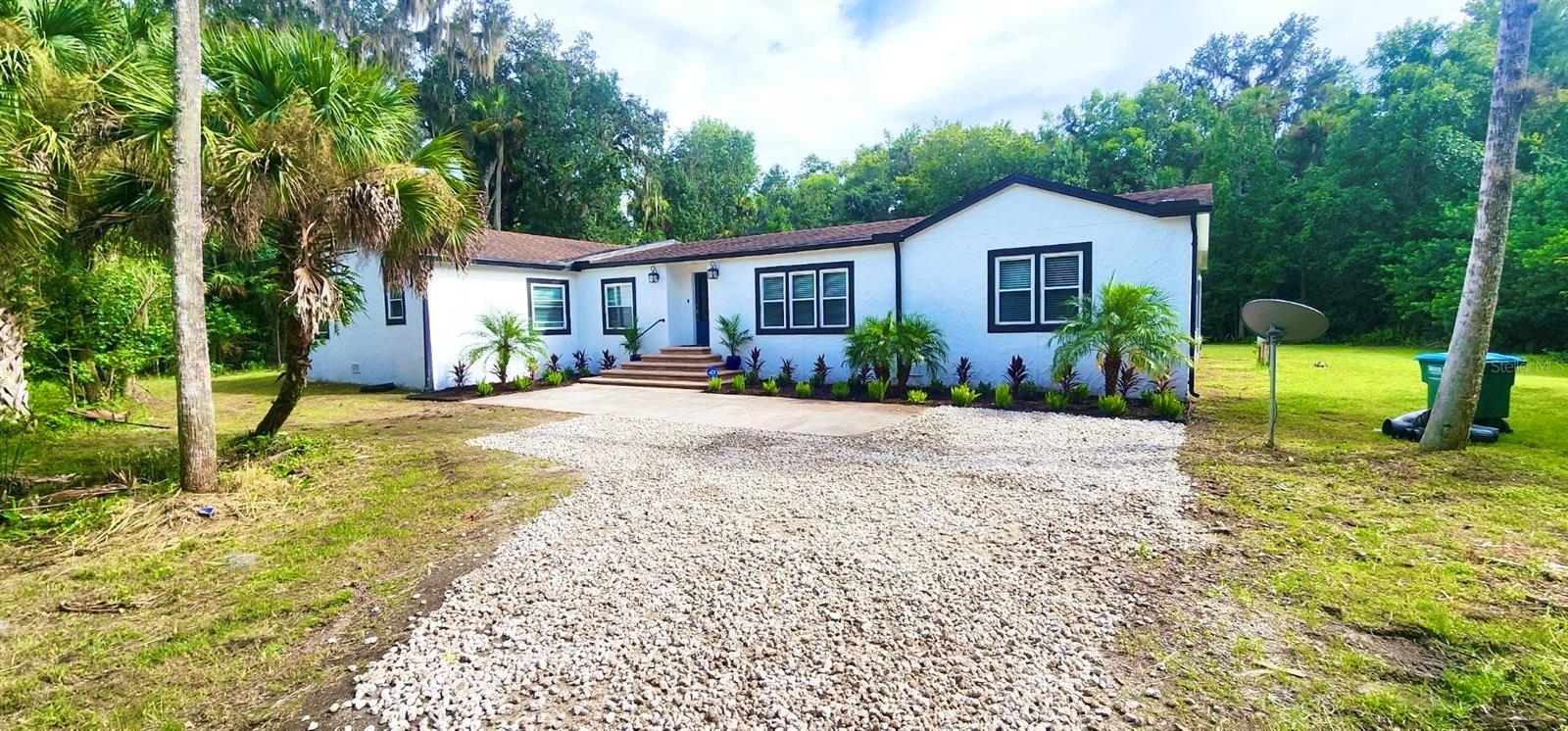 The best of all worlds! Huge house, open floor plan, 5 bedrooms and three bathrooms, excellent schools - with no HOA and plenty of privacy! This home is located in the Black Hammock on 5 lush acres. Enjoy your semi private driveway to a little slice of heaven with this oversized home that delivers privacy, but yet close to major hwys. Two generously sized living rooms provide versatile areas for relaxation and entertainment AND two generously sized primary bedrooms with en suite baths. Three additional bedrooms and a third, full size bathroom. All the bedrooms have walk in closets! This builder thought of everything! Let's not forget the over sized kitchen which comes equipped with essential appliances. Brand new washer and dryer. Step out back through two separate entrances to a huge screened in porch that provides serene wooded views on this five acre parcel. This property is Nestled in a peaceful area yet conveniently close to Oviedo's shopping, dining, and reputable schools, this property provides both tranquility and accessibility. Major highways and Orlando International Airport are less than 30 minutes away, making this home a perfect blend of seclusion and convenience. All applicants are required to do a credit and background check. Renters insurance is required..