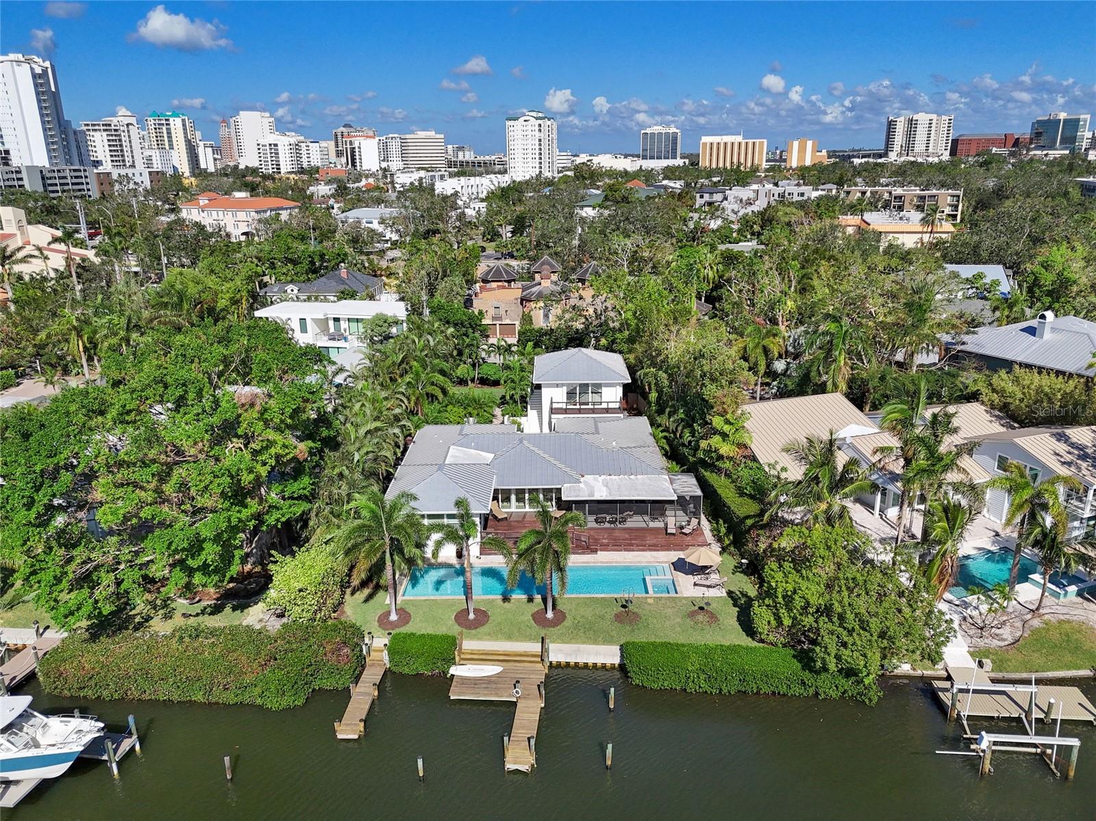 Welcome to this stunning 3 bedroom/Den with 4 En-suite Bathrooms contemporary home, including a Mother-in-Law Suite, ideally situated on Hudson Bayou. Easy walking distance of a half mile to the vibrant heart of Sarasota and Sarasota Bay—perfect for boating and nature enthusiasts! Nestled in a peaceful cul-de-sac, this beautifully remodeled residence was thoughtfully updated in 2015, with a lovely saltwater pool added in 2016, along with a new seawall, landscaping, covered lanai, deck, and a refreshed dock. NO WATER ENCROACHMENT.
With 100 feet of waterfront and protected dockage for up to four boats, you’ll enjoy serene views of the water, captivating sunrises, and breathtaking sunsets. As you approach the home, you'll be greeted by lush landscaping leading into a spacious courtyard, ideal for entertaining. Sliding impact glass doors and windows seamlessly connect this inviting outdoor space to the open floor plan inside.
This home is designed for both relaxation and entertainment, featuring elegant finishes and ample space that opens to the deck, pool, and scenic views of Hudson Bayou. The modern gourmet kitchen, complete with an island and 5-burner gas stove. Whole house water filtration system. Significant cabinet and storage, ample counter space, and stainless appliances are perfect for the discerning cook. It flows into a screened lanai, perfect for enjoying the water views and ample aquatic wildlife. Watch the manatees and dolphins swim by you as the birds sing their own songs.
The spacious master suite has access to the deck and large windows that frame the tranquil waterfront. Additionally, the 528-square-foot Mother-in-Law Suite above the two-car garage which includes a full bath and plumbing for a kitchenette, offering flexibility for visitors or an in-home office or studio apartment.
This exceptional home is truly a gem in one of Sarasota’s most desirable locations, combining contemporary elegance with easy access to the city and a relaxed waterfront lifestyle.