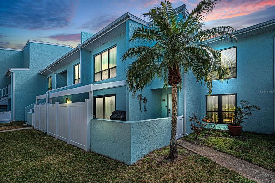 Live the Direct Waterfront Lifestyle in Indian Rocks Beach in this contemporary 2-bedroom, 2.5-bath, two-story residence in the sought-after waterfront community of Windrush Cove delivering an elevated, sun-soaked Beach lifestyle. Perfectly positioned along the serene Intracoastal shoreline with unobstructed waterfront views, this light-filled two level condo offers seamless indoor–outdoor living and a thoughtfully reimagined interior styled in soft coastal hues and a subtle beach-inspired palette.  Enjoy the benefits of a secluded waterfront enclave featuring a resort-style heated pool, clubhouse, fitness area, and more. With over 1,200 square feet of open-concept nautical living, the residence is bathed in natural light and refreshed with a modern coastal design. The spacious layout includes abundant storage, a well-designed split bedroom plan, and a large, pergola covered patio at the entry, all just a short stroll to the beach and moments from everything IRB offers. Step inside to an awe-inspiring main level showcasing an expansive, ultra chic Kitchen, Living, and Dining area with island-inspired tones and an effortless flow to the waterfront patio through brand-new impact sliding glass doors — the perfect setting for tangerine sunrises and sunsets. The fully renovated, coastal-inspired designer kitchen infused with soft, seaside hues feature contemporary navy cabinetry, quartzite countertops, new stainless-steel appliances, and a generous social island ideal for the chef who loves to stay connected. A stylish half bath is conveniently located off the entry.  Upstairs, the large Primary Suite offers a spacious sitting area, two walk-in closets, and a picture window framing the shimmering Community pool and coming sunset!  The Primary suite is complemented by a beautifully updated full bath in a soft shoreline-inspired palette. A second bedroom features an ensuite bath, a generous sized walk-in closet with a stackable washer/dryer nicely tucked away. Additional valued features include fresh interior paint, new craftsman baseboards & doors, an abundance of storage areas & nooks, newer HVAC, one car carport with storage just out front and a cohesive coastal color palette throughout. Pet-friendly with low HOA fees covering roof, exterior maintenance, water, trash, sewer, and master insurance (including flood). Rentals permitted with a 1-month minimum, preserving the community’s boutique feel. Located in the heart of Indian Rocks Beach — a golf-cart-friendly coastal town with parks, playgrounds, a boat ramp, beach access, and vibrant local shops and restaurants, this residence offers effortless access to Tampa, Pinellas County, and nearby airports. Coastal elegance meets modern luxury in this beautifully remodeled waterfront retreat with unobstructed waterfront views —where mornings start with sunshine on the water and evenings end in pure coastal calm.