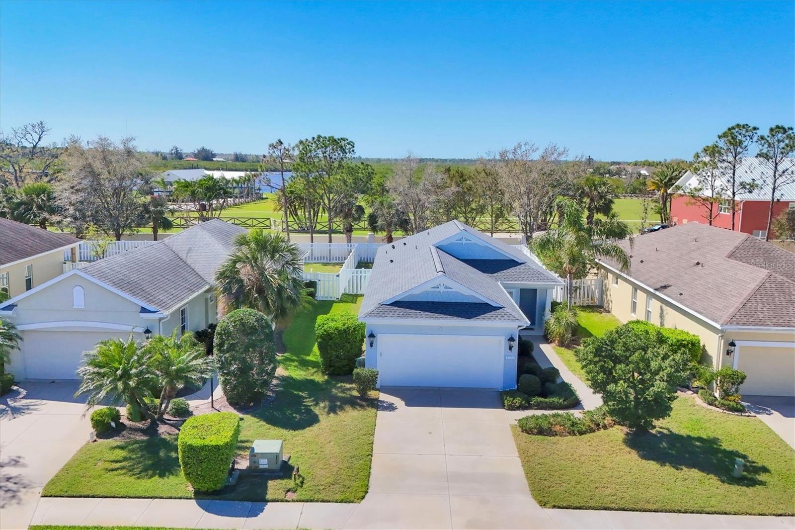 Welcome to this charming residence in the gated River Sound community in Bradenton. Two-bedroom, possibly three with den, two-bath home offers 1,293 square feet of thoughtfully designed living space with modern updates and exceptional community amenities. This meticulously maintained home features a new 2025 roof and gutters. Just six months ago a new water heater, a freshly painted exterior, all window screens replaced, and the lanai rescreened, with a new fan added. All appliances, including the washer and dryer, were just replaced in 2023. The inviting open-concept living area includes engineered hardwood flooring throughout the home and seamless access to the backyard through sliding glass doors. At front of the home, a versatile den offers the ideal space for a home office, reading or TV room, or additional guest accommodation. The updated kitchen, complete with newer appliances, features an eating area and a breakfast bar, ideal for casual dining and entertaining. The primary bedroom is a private retreat with an en-suite bath, large walk-in shower and serene views of the backyard, enhancing the sense of peace and relaxation. The second bedroom and updated guest bath give your guests privacy they desire. The exterior of the home is enhanced by mature landscaping in the front yard, offering welcoming curb appeal. The backyard will be your pets favorite place, beside the dog parks, with its privacy fence and the doggy door for ease of access. You too will feel it is ideal for enjoying the outdoors in a private and tranquil setting. The two-car garage includes additional storage and a workbench, catering to practical needs. River Sound, a gated community, offers exceptional amenities, including a sparkling community pool and spa, two dog parks, a playground and a fishing dock along the Braden River. The community features well-maintained sidewalks, lush landscaping and offers walking trails and picturesque sunset views over the river, enhancing its inviting atmosphere. Centrally located, this home is minutes from premier shopping, dining, downtown Manatee with its Riverwalk and stunning Gulf Coast beaches. Easy access to the interstate to go north to St. Pete and/or Tampa. Experience the balance of lifestyle and location at this charming home.