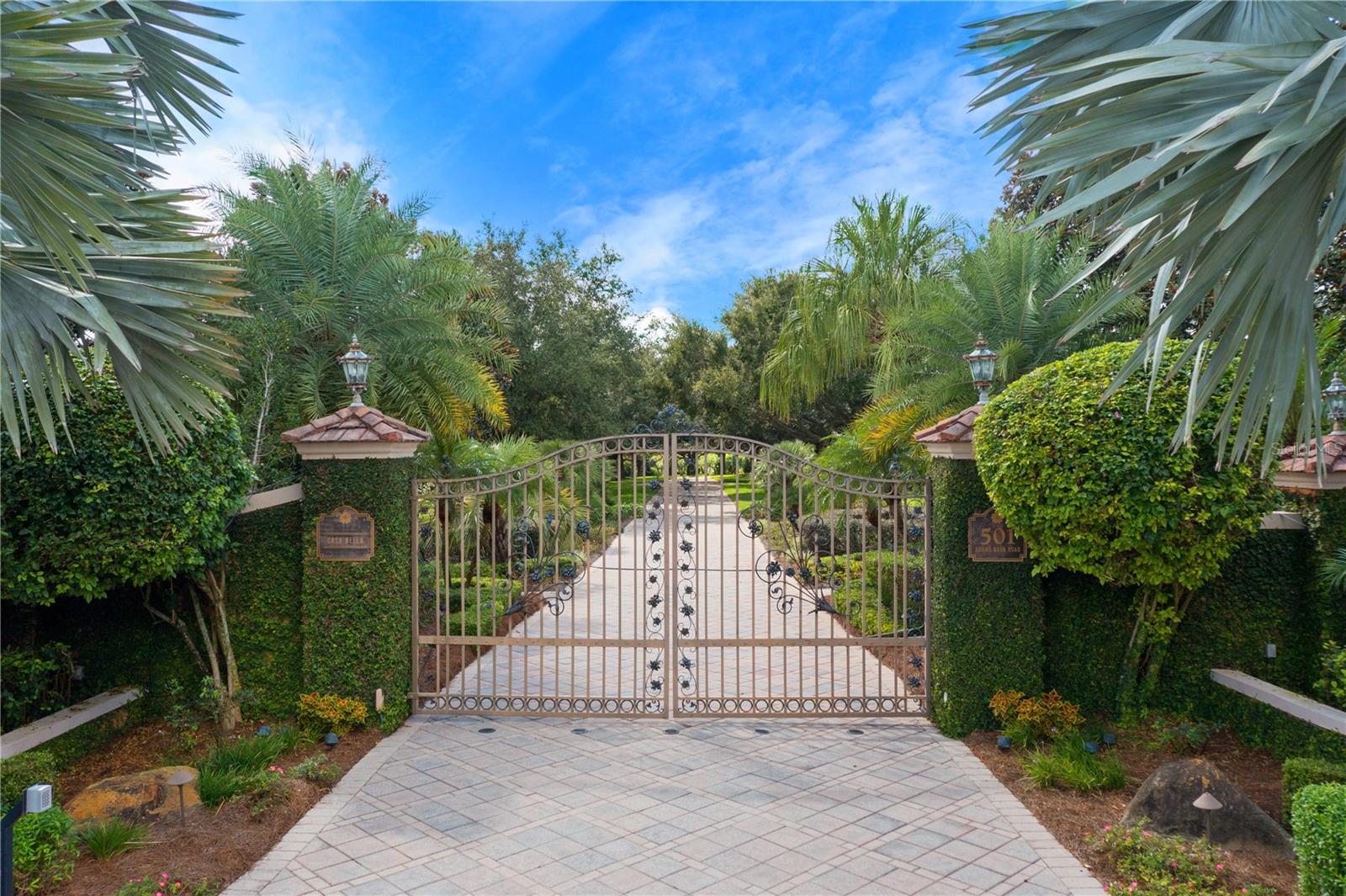 PRICED ADJUSTMENT ~ NOW OFFERED AT $4,800,000 FROM THE APPRAISED VALUE OF $6,250,000
This exquisite estate awaits the discerning buyer in Auburndale. Nestled on 44.30 lushly landscaped acres with over 2,300 feet of water frontage, this picturesque property is truly a piece of paradise. Beauty abounds upon arrival, from the grand circular driveway and water fountain to the verdant vegetation in the front yard. Enter the solid mahogany doors to a gracious interior comprised of 9,215 square feet of luxurious living space. The foyer is adorned with a free-standing spiral staircase with hardwood steps, along with a marble compass-medallion floor detail and a double tray ceiling. Meticulously designed for the chef at heart, the light and bright kitchen boasts two wall ovens, a warming drawer, Sub-Zero refrigerator, Miele dishwasher, a six-burner Thermador gas range and an eat-in area. For special occasions, the formal dining room is flooded with natural light and features a crystal chandelier. Gather with loved ones in the family room, complete with a custom built-in fireplace and woodwork. For your secluded escape, the master suite is a resplendent retreat with a butler’s pantry, a dressing area with vanity, as well as access to the oversized terrace. The suite also includes dual walk-in closets and separate baths, one with a steam shower and the other with a Jacuzzi tub, walk-in shower and gas fireplace. With four more bedrooms, a study with a full bath and closet which could also be used as a secondary primary suite, a one-bedroom, one-bath in-law suite with a private entrance, there is plenty of space to accommodate guests. This remarkable residence also features a formal living area with a saltwater aquarium, a game room with a wet bar and a sauna. For peace of mind, the home is equipped with two septic tanks, two wells, a water softener system, seven air-conditioning units with two recently replaced, a central vacuum, and programmable lights both inside and out. Store your prized possessions in the gorgeous two-car garage, offering a tiled floor, cherry wood walls and ceilings. An additional two-car guest garage is available for more storage. The outdoors encompasses an opulent oasis featuring a palatial pool with a waterfall edge. For your recreational pursuit, make your way to the tennis courts or private, covered boat dock. A gardener’s garage and pumphouse can also be found on site. Steeped in beauty and capturing panoramic views throughout, this hidden gem presents an exceptional opportunity. Possibility or short term seller financing - terms to be discussed. For a video tour click or copy paste https://www.youtube.com/watch?v=3-yTELW5xyY Room Feature: Linen Closet In Bath (Primary Bedroom).