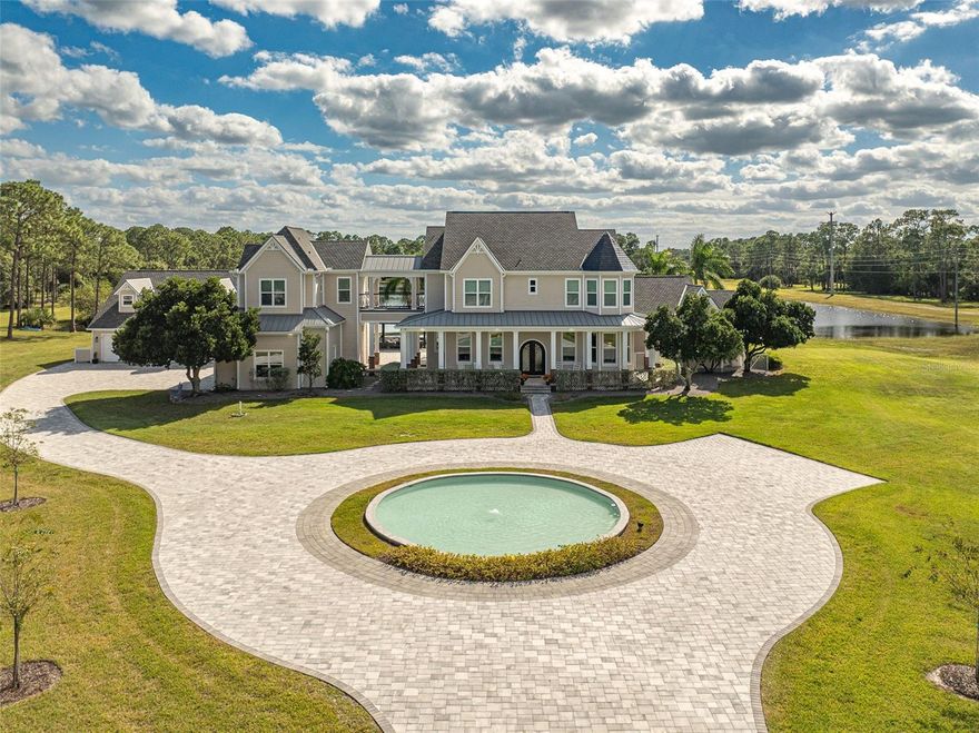 Overlooking the pool as well is a massive billiards and entertainment wing, outfitted with a full kitchen, bath, and lounge space perfect for game days, parties, and gatherings. Outside is where this estate becomes truly unforgettable. The world-famous pool shaped like Mickey Mouse offers resort features including sunken dry seating areas, beach entry, hot tub, swim-up bar, and multiple water features. The expansive patio includes a covered bar and outdoor kitchen, a fire pit, and two swinging daybeds beside a custom fireplace, all positioned to take in the spectacular sunsets over the lake. With 18 fully fenced and gated acres of gently rolling land, this property is a dream for outdoor enthusiasts. Ideal for horses, ATVs, side-by-sides, paddleboards, jet skis, and more, the estate even includes a paved go-kart track tucked away at the back of the property. You also can enjoy pickleball and basketball on the lighted court! And with two separate three-car garages, there's no shortage of space for all your toys. Finished with mature landscaping and custom exterior lighting, this property transforms beautifully at night, becoming a glowing private oasis. This is a one-of-a-kind estate that must be seen to be fully appreciated, an entertainer's paradise, a family retreat, and a luxury escape all in one. This property is also approved for short-term rentals, so if you're looking for an income producing investment, the options are limitless here.