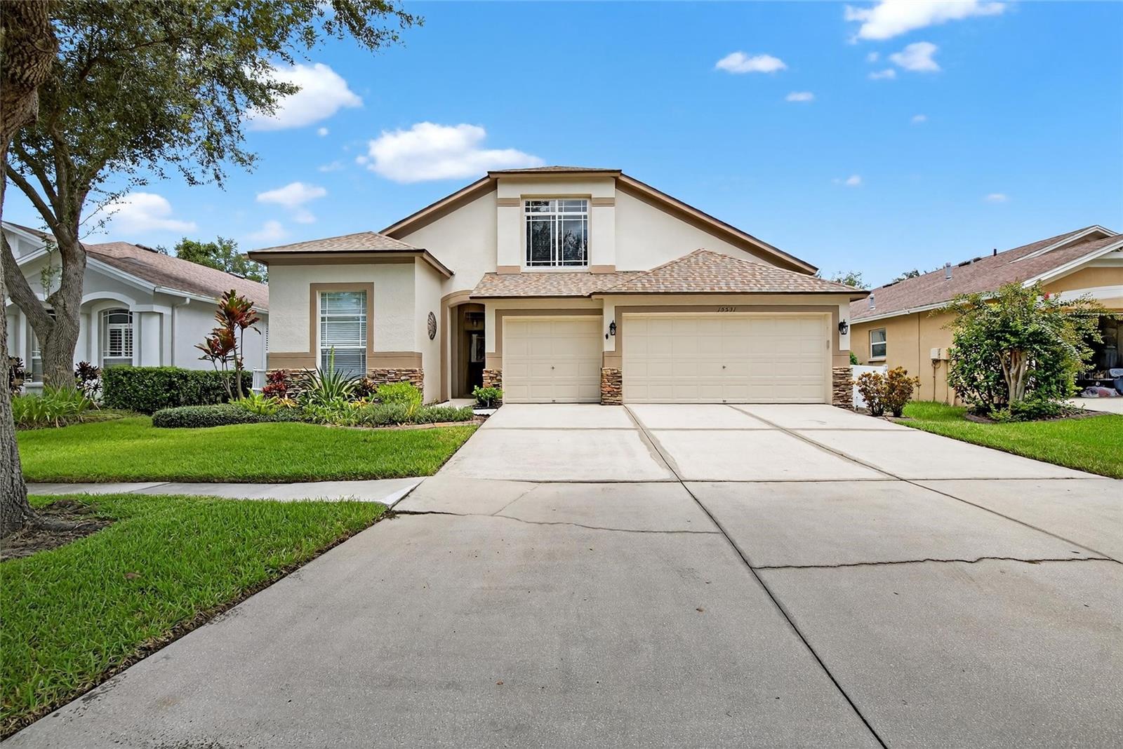 One or more photo(s) has been virtually staged. Luxury & Lifestyle in FishHawk Ranch’s Gated Martin Meadow.
Welcome to the gated Martin Meadow neighborhood of FishHawk Ranch, where resort-style living meets everyday comfort. This Suarez-built 5-bedroom, 3-bathroom home with a 3-car garage boasts stunning curb appeal with stacked stone accents, mature Florida-native landscaping, and the ever-popular “Jasmine” floor plan, complete with soaring volume ceilings.
Step inside to find formal living and dining rooms perfect for hosting, and an open-concept family room bathed in natural light. Sliding doors topped with an arched transom window lead to the screened lanai, where you’ll enjoy Florida’s famous indoor-outdoor lifestyle.
The kitchen is ready for culinary adventures with stainless steel appliances, wood cabinetry, neutral gray Corian countertops, a generous center island and a bright breakfast nook overlooking the backyard.
The owner’s retreat is a private sanctuary, flooded with light and featuring dual walk-in closets, a spa-inspired en-suite with double sinks, a jetted tub, and a walk-in shower. The triple-split floor plan gives everyone space: two bedrooms share a full bath in their own wing, a fourth bedroom has its own nearby bath (ideal for guests or in-laws), and upstairs you’ll find the fifth bedroom for work, play, or extra privacy.
Outside, an extended screened and covered lanai overlooks a fully fenced backyard with lush green grass, perfect for pets, play, and weekend barbecues.
Living here means access to FishHawk Ranch’s top-tier amenities: multiple resort-style pools, the Aquatic Center, miles of trails, fitness center, skate park, Park Square shops & dining, and more. Plus, A-rated schools.
This is more than a house… it’s your next chapter in one of Tampa Bay’s most sought-after communities.
Schedule your showing today and see why life is better in FishHawk Ranch.