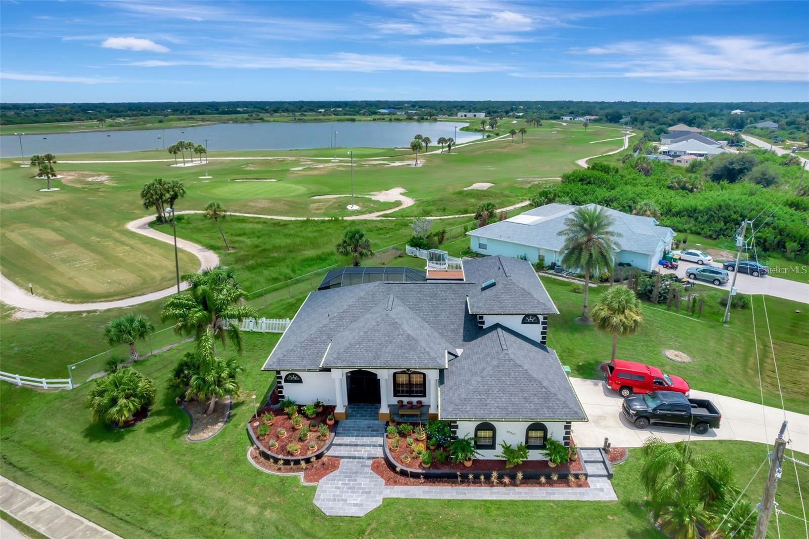 Welcome to your dream home, perfectly situated just 7 minutes from Manasota Key and 20 minutes from the pristine shores of Boca Grande Beach. As you enter, you'll be greeted by an open floor plan that seamlessly blends indoor and outdoor living. The expansive living area is bathed in natural light, leading to a gourmet kitchen that is a chef's delight. The kitchen boasts a stunning 13-foot-long island with waterfall edges, perfect for big families or gatherings with friends, along with high-end appliances and custom cabinetry. This spacious four bedroom, three and one-half bathroom residence offers luxury living with breathtaking views of the golf course. The primary suite is a private oasis, featuring a spa-like bathroom with a soaking tub, a walk-in shower, and dual vanities. The additional three bedrooms are generously sized.Head outside to your private pool area, where you can relax and enjoy the tranquil views of the golf course. The outdoor space is designed for entertainment, with a covered lanai and plenty of room for outdoor dining. For those seeking panoramic views, the rooftop deck is the crown jewel of this home. Imagine sipping your morning coffee or enjoying evening sunsets with a 360-degree view of the surrounding area. With its prime location, luxurious amenities, and close proximity to some of Florida's most beautiful beaches, this home is the perfect blend of elegance and convenience. Don't miss the opportunity to make it yours! Incentives with preferred Lender.