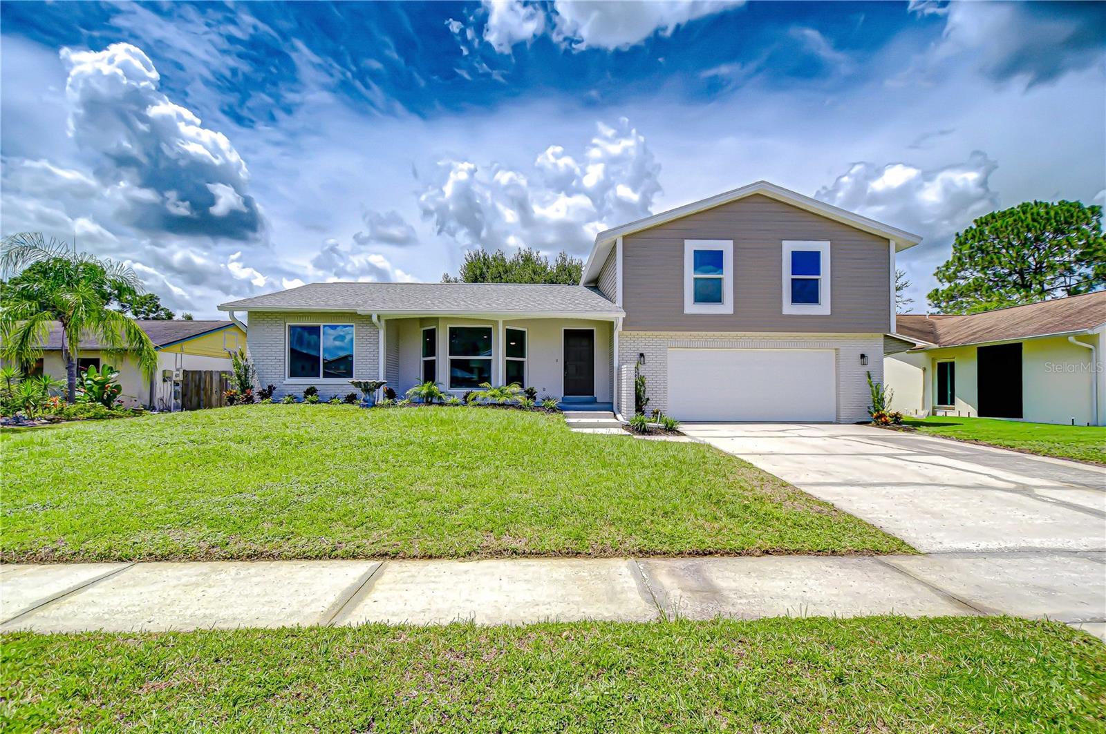 Contemporary Northdale Retreat with Pool & Spa – Stylishly Updated and Move-In Ready
Set on the edge of Carrollwood in sought-after Northdale, this contemporary 3-bedroom, 2.5-bath pool home blends modern updates with timeless comfort. Built in 1981 and thoughtfully refreshed, the residence offers 1,614 sq. ft. of living space with an open-concept design that feels far larger than its size. Out back, a screened lanai showcases a sparkling freeform pool and spa enhanced by a dramatic rock formation with fountains—an inviting private retreat perfect for relaxation or entertaining. A freshly painted brick façade with a charming bay window, coach lights, and a brand-new garage door creates striking curb appeal and sets the tone for what awaits inside. Step through the front door into the welcoming foyer with a convenient hall closet, where NEW luxury vinyl plank flooring flows seamlessly throughout the first floor. Newly updated windows and doors (just 3 years old), offers both style and efficiency. Inside, the spacious living room is highlighted by the dramatic bay window that fills the space with natural light. The open flow continues into the family room, where oversized sliding glass doors draw the eye toward the lanai and pool beyond. For special occasions, a formal dining room adds flexibility and elegance, making this home as functional as it is inviting. The heart of the home is the beautifully updated kitchen, showcasing NEW Shaker cabinets, gleaming Quartz countertops, a designer tile backsplash, recessed lighting, and a stainless-steel deep sink. A full suite of appliances and a convenient closet pantry complete the space, making it as functional as it is stylish. Just three steps down, a NEW guest bath features a Quartz-topped vanity, while the adjacent garage entry reveals the laundry area with washer and dryer, built-in storage, a workbench, and a door leading directly to the backyard. Ascend the staircase to the second floor, where a hall bath is thoughtfully appointed with a Quartz topped vanity, undermount sink, double drawers, and a tub/shower combination. Double doors open to the spacious primary suite, complete with both a standard closet and a generous walk-in, plus a private ensuite bath offering a Quartz topped vanity and a seamless glass-enclosed tiled shower with a bench seat and grab bars for added comfort. A hallway linen closet adds convenience, while secondary bedrooms are comfortably sized and enhanced with ceiling fans. With its stylish updates, thoughtful layout, and resort-style outdoor living, this Northdale retreat is move-in ready and waiting to be enjoyed. Conveniently located near shopping, dining, golf courses, and top-rated schools, it offers the perfect blend of comfort, convenience, and lifestyle. Don’t miss the chance to make this pool and spa home your own—schedule your private showing today and experience all it offers.