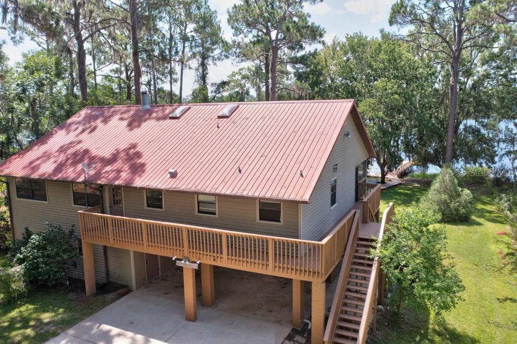 Lovely 3/3 lake home on .76 acres perfectly positioned with amazing lake views upstairs and downstairs. Riley Lake is a spring fed lake where you can enjoy swimming, kayaking, fishing or simply relax under the shade trees watching the wildlife. Your private dock is an excellent location to watch a beautiful sunrise or sunset. This 2 story home’s main living area is upstairs with 3 bedrooms, 2 baths, an oversized living room and a laundry room conveniently located off the kitchen. Downstairs is a 28’x28’ open concept room with a kitchen and full bath that can be used as a recreation room or even mother-in-law/guest suite. The home feels very cozy with a wrap around deck and a 12’x54’ screened in porch off the upstairs living room, providing a panoramic lake view. Besides the beautiful views, a few special features of this home are an elevator lift, a whole-house generator, metal roof, fireplace, and wireless controlled irrigation system. Come see this amazing home while it lasts!