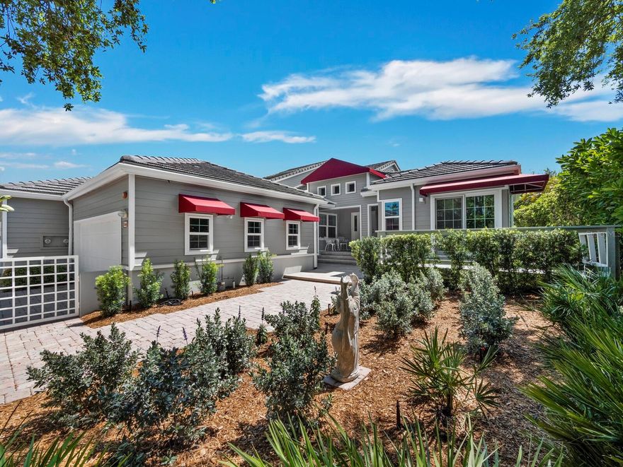 Located in one of the most sought-after villa communities on Longboat Key, this well-kept 2-bedroom, 2-bath home in Winding Oaks lives more like a single-family residence—without all the upkeep. Behind the gates of Bay Isles, it offers a great opportunity to enjoy a quiet, established neighborhood known for its natural beauty and relaxed feel. A paver driveway and walkway, surrounded by mature landscaping, lead you to the front door. Inside, high ceilings and warm wood floors immediately make the space feel open and inviting. The finishes are neutral and timeless, and the natural light really does the rest. Impact glass throughout adds both comfort and peace of mind. The main living area flows easily, with a striking corner of sliding glass doors that brings the outdoors in and opens to a spacious, screened, deck. It’s the kind of space you’ll actually use—whether that’s for entertaining, relaxing, or just enjoying the greenery around you. 
The kitchen is nicely laid out with stone countertops, stainless appliances, a tray ceiling, and a large window that keeps things bright. Both bedrooms are generously sized. The primary suite feels like a true retreat, with vaulted ceilings, a walk-in closet, and sliding doors that open to the deck with peaceful nature views. The bathroom is spacious, featuring dual vanities, a Jacuzzi tub, walk-in shower, and well-done tile details. Additional highlights include a two-car garage and a floor plan that offers a nice balance of openness and privacy. Winding Oaks is part of the Bay Isles Harbourside golf course community and offers a gated entrance, community pool, and access to Bay Isles amenities—including deeded beach access through the private Bay Isles Beach Club. It’s an easy, comfortable lifestyle in one of Longboat Key’s most desirable communities.