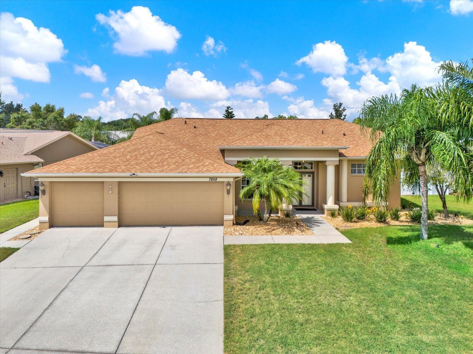 One or more photo(s) has been virtually staged. Welcome to your serene tropical oasis in New Port Richey. This delightful 3-bedroom, 2-bath home offers over 1,700 sq ft of luxury living space, blending modern elegance with peaceful surroundings.
Step through the double front doors into a bright, airy floor plan with high ceilings, luxury vinyl plank flooring, and abundant natural light. The spacious kitchen features upgraded stainless steel LG appliances, including a new microwave and dishwasher, updated kitchen countertops, a pantry, an eat-in breakfast bar, and a coffee bar with a unique chalkboard backsplash and a dedicated coffee maker line to the refrigerator—perfect for entertaining.
The primary suite is a private sanctuary with a barn-style sliding door to the spa-like ensuite bath, walk-in shower, separate tub, double vanity, walk-in closet, and private pool access. A new bedroom door to the backyard adds extra convenience.
Two additional bedrooms and an updated bath provide comfort and flexibility for guests or a home office. Throughout the home, you’ll find new ceiling fans, updated paint, electric shades, and thoughtful touches including a sliding doggy door.
Outside, enjoy beautifully landscaped grounds surrounding the enclosed, screened-in heated pool, upgraded with Florida glass screening around the lower panels and a new salt chlorinator system.
The property also features a new water softener installed in 2025, a fully fenced yard, and an oversized three-car garage equipped with generator hook-up and diamond plate design vinyl flooring. A functioning Kasa video doorbell, Nest thermostat, and dedicated laundry area with washer and dryer included provide added convenience.
Located minutes from shopping, dining, schools, Jay B. Starkey Wilderness Park, and offering easy access to the Suncoast Parkway and US-19.
Special Opportunity: Assumable VA loan at 5.75 for qualified buyers—an excellent option for today’s market.
Don’t miss this beautifully upgraded, move-in-ready home. Schedule your private tour today!