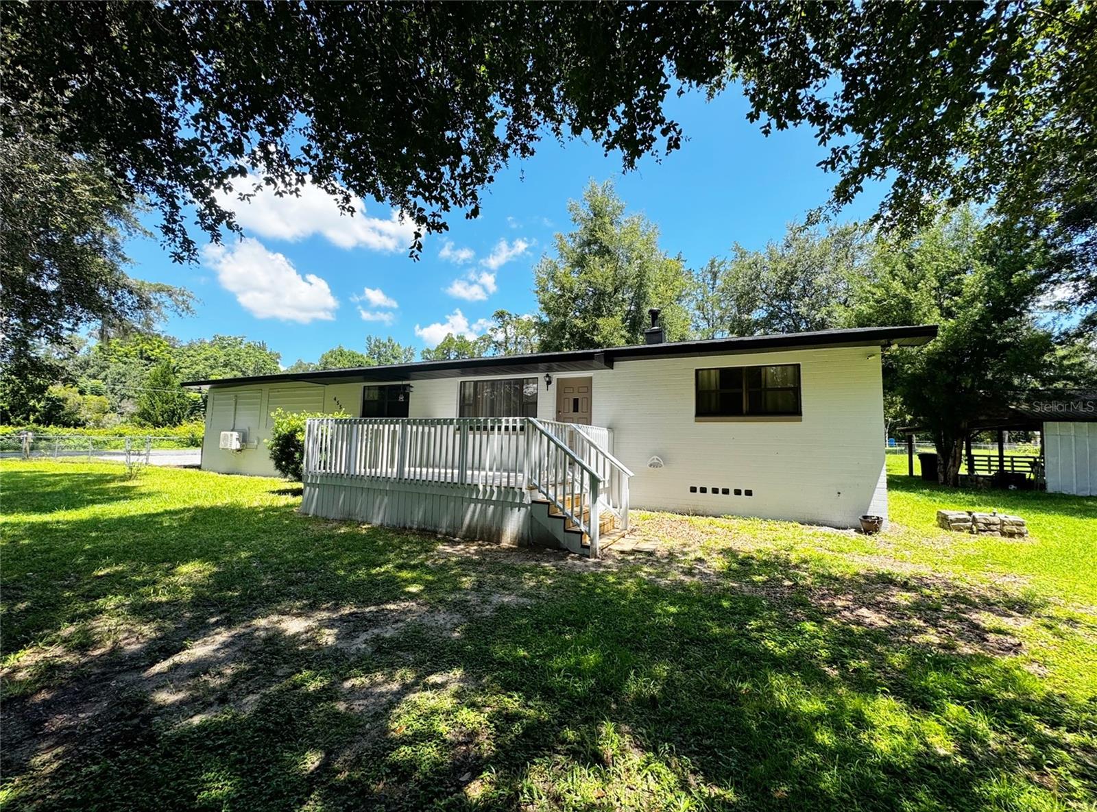 Enjoy the tranquil lifestyle living on an almost full acre lot (.90) in a desirable Ocala area located on one of Marion County's Scenic roads featuring luxury homes, horse farms, and minutes to access the Florida Greenway Trail. Envision having your morning coffee or relaxing happy hour on the front deck or the backyard pole barn. Other notable features of this split plan home is the 21x21 Bonus Room, Remodeled Kitchen and bathrooms, HVAC June 2025, Roof 2022, a 16x12 storage shed, and completely fenced yard. Close access to grocery shopping center, I-75, and College Rd featuring a variety of shopping/restaurants.