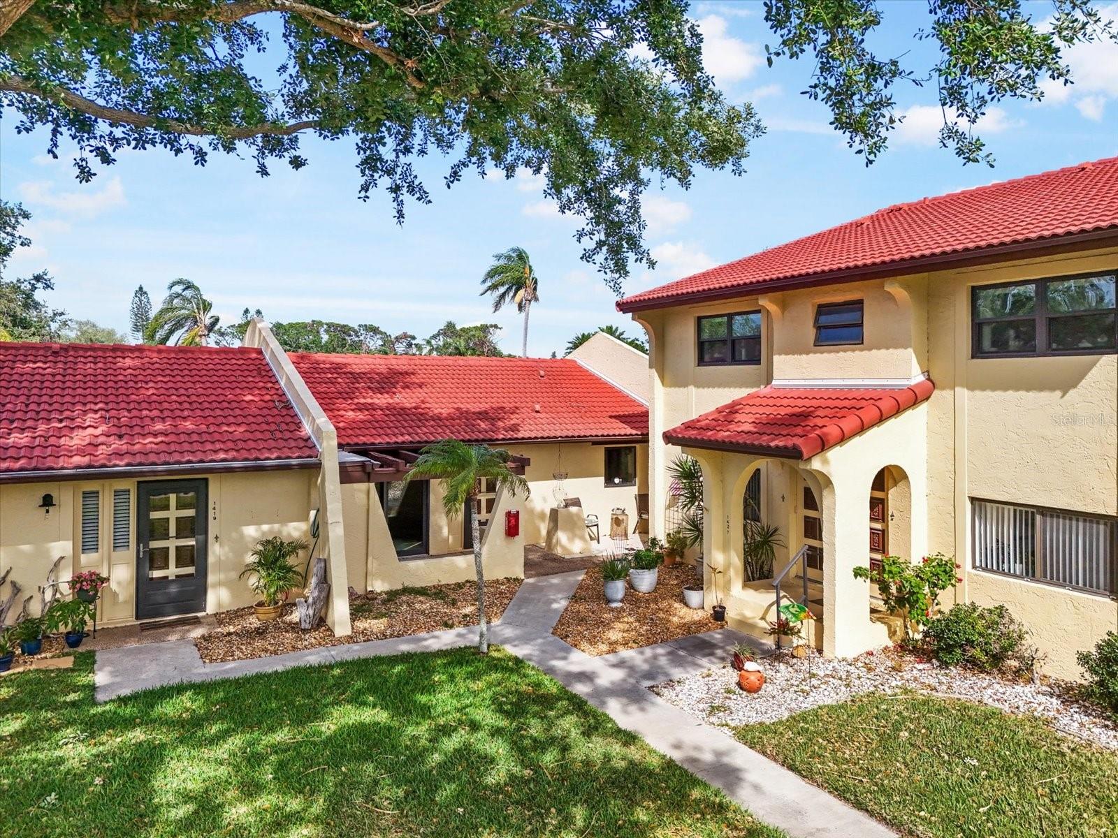 Resort-Style 55+ Living Just Minutes from Anna Maria Island
Welcome to Meadowcroft North, where vibrant, active living meets peaceful comfort—just moments from the sandy shores of Anna Maria Island. Located in the heart of West Bradenton, this beautifully maintained 55+ community offers an exceptional lifestyle with amenities that include an Olympic-sized heated pool, clubhouse, tennis courts, library, billiards room, dance floor, and a serene lake for fishing.
This charming single-story, villa-style condo has been thoughtfully updated for both style and comfort. Constructed with durable concrete block, it features impact-rated windows, recessed lighting, new ceiling fans, and a brand-new AC system with updated ductwork for cool, clean air year-round. A recently replaced tile roof adds peace of mind and long-lasting value.
Step into a renovated kitchen that boasts crisp white cabinetry with glass-front doors, quartz countertops, and a stylish tile backsplash. The updated bathroom features a modern vanity, updated lighting, and a walk-in shower. Throughout the home, you'll find luxury vinyl flooring, new baseboards, and a welcoming, light-filled ambiance enhanced by electric shades.
Enjoy not one, but two private outdoor retreats: a front porch overlooking a lush courtyard with a majestic oak tree, and a screened back lanai with privacy shades and an additional deck—ideal for morning coffee, evening dinners, or simply soaking in the Florida sunshine. The primary bedroom offers generous space for a king-size bed, plantation shutters, and a built-in closet system. Additional features include an interior laundry closet, covered carport, and outdoor storage.
The low monthly fee includes internet, cable, water, sewer, trash, pest control, amenities, and exterior maintenance—making life simple and carefree. Pets are welcome, and the location is ideal with nearby access to restaurants, shopping, golf courses, GT Bray Park, the YMCA, and top medical facilities.
Whether you're looking for a seasonal escape or a full-time residence, this meticulously updated villa offers the perfect blend of resort-style amenities and everyday comfort.