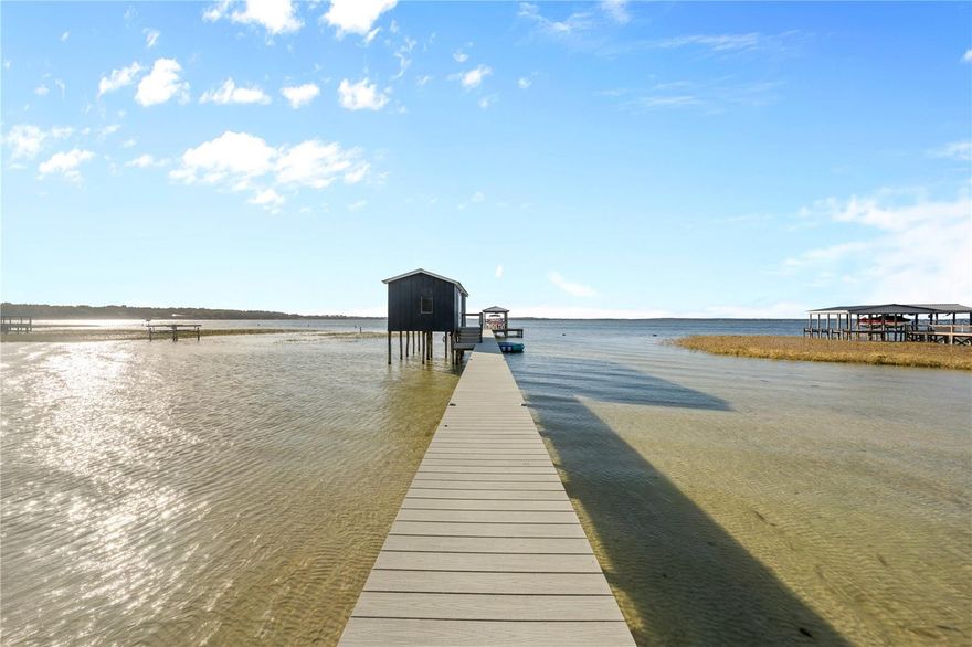 Enjoy breathtaking sunsets and sweeping lake views from this beautifully updated four-bedroom, 2.5-bath home on the shores of Lake Weir. Designed for both relaxed living and entertaining, this property offers the perfect blend of comfort, style, and outdoor enjoyment.
The gorgeous kitchen features all GE appliances, tile backsplash, pull-out pantry cabinetry, and exceptional storage, creating a functional yet elegant heart of the home. The primary suite is a private retreat with a custom walk-in closet with barn sliding doors, and a spa-inspired bath featuring a freestanding soaking tub, doorless walk-in shower with step entry, and dual vanities.
Outdoor living truly shines with brick pavers leading to a sandy beach, a basketball court, and a dock with boathouse and boat lift, complete with a bar and seating area—perfect for hosting friends or unwinding while watching Lake Weir’s unforgettable sunsets. Multiple screened porches provide ideal spaces to relax and take in the views.
Additional highlights include a large custom walk-in pantry, a custom mudroom with built-in cabinetry and shelving, and a convenient half bath for guests.
This exceptional lakefront home offers the lifestyle Lake Weir is known for—sunsets, water, and memories waiting to be made.
Whether you’re seeking full-time lakefront living or a weekend escape, this is the dream vacation home you’ve been waiting for.
Make an appointment today to view YOUR new home!!!