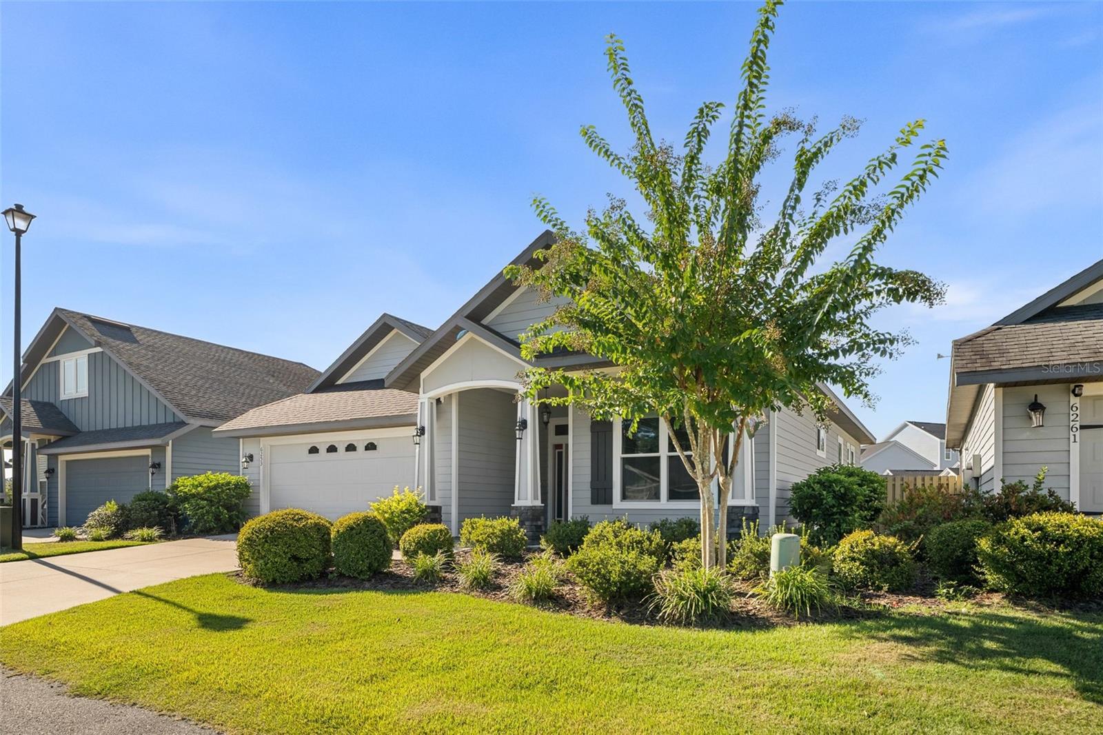 Welcome to Finley Woods and this gently lived in energy efficient three bedroom two bathroom home in the heart of north central Florida. Stepping into the foyer from the charming front porch, you’ll immediately appreciate the high ceilings, crown molding, and wood-look ceramic tile found throughout the living spaces. A stunning tray ceiling sets off the family room, and the open concept kitchen is flooded with natural light from the large skylight towering over the granite covered island and counter height breakfast bar. With an oversized pantry, stainless appliances, and solid wood cabinetry, you’ll love staying in for dinner. The spacious dining area opens through French doors to an inviting covered lanai with relaxing back yard views. Quality and comfort continue into the primary suite with a spa like bathroom featuring a massive shower, double vanities, and a walk-in closet. The spit floor plan includes two additional bedrooms and a full bathroom off the front hall. Long known as Gainesville’s green builder, Tommy Williams Homes incorporated many energy saving features during construction including solar panels, double paned windows, state-of-the-art insulation, and a multi-stage HVAC system creating a home you can feel good about and afford to live in. Finley Woods is located in beautiful and sought after southwest Gainesville convenient to many shopping and dining options in Celebration Pointe and Butler Town Center; North Florida Regional, VA, and Shands Hospitals; as well as Santa Fe College and the University of Florida! Call today to see this like-new home for yourself.