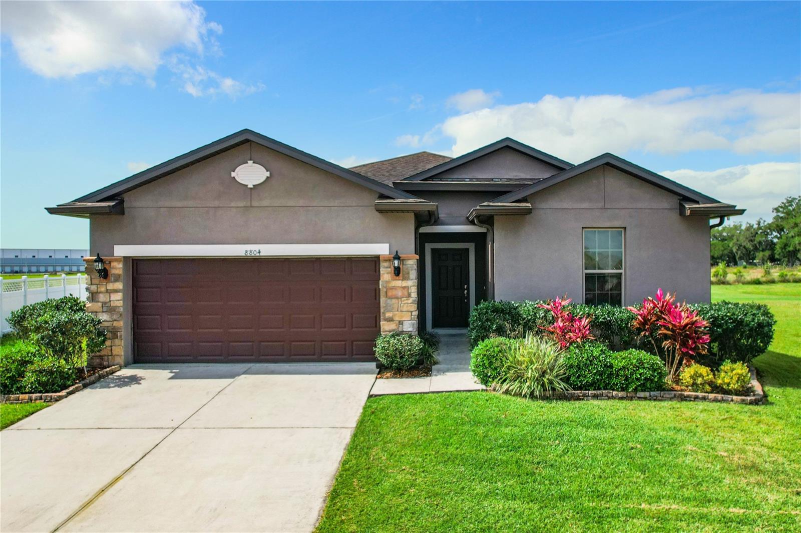 Gorgeous 2017 pool home, where all the hard work has already been completed for you! 18" Ceramic Tile and 10' Ceilings greet you entering the foyer leading to a split bedroom, open floor plan making optimal use of every inch of square footage. Your heart skipped a beat picturing entertaining friends and family in the vast kitchen featuring a generously sized Center Island, thick Granite Countertops and an abundance of 36" Wood Cabinetry. The Master Bedroom offers ample space for your King-Sized Bed and bulky bedroom furniture, with a Master Bathroom showcasing Dual Sinks and Walk- In Shower. Separate Laundry Room and an Oversized 2 Car Garage. Exiting thru the rear sliding glass doors onto the Covered & Screened Lanai overlooking the massive, fenced backyard, you envisioned yourself sipping a cool beverage, enjoying the Water View while watching your family frolic in the Inground Salt Water Pool.