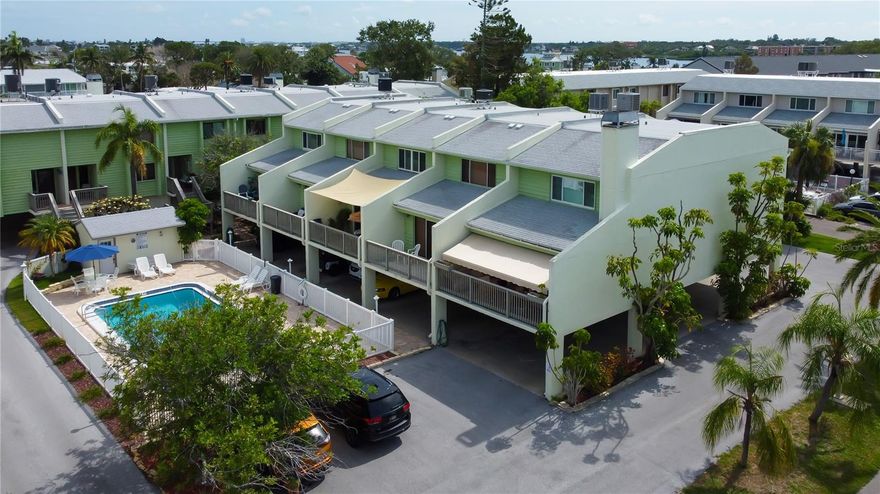 Welcome Home to this coastal water retreat.  This home gives meaning to living the Florida lifestyle.  This elevated property is just a short walking distance-6 blocks- to the pinellas beaches.  Because this property is elevated , there was no storm damage to this home.  As soon as you enter this home you are welcomed into the beautifully designed kitchen complete with quartz countertops, breakfast bar and stainless appliances. Just past the living area you can enjoy the beach air from your private balcony overlooking the pool area.  There is one bedroom downstairs which can also be utilized as an office and the other two spacious bedrooms are upstairs .  There is also an unheard of 5 parkings spaces (4 that are covered under the unit).  This is a small 12 unit complex and the road is very quiet and private.  Conveniently located to many popular eateries, beaches and shopping.Also very close in proximity to the waterways of our area and Pinellas County Boat Ramps.    Your condo fees covers many services which provides peace of mind.  This property is move in ready and seller is willing to negotiate furnishings. Don't hesitate on this one.  Call me today to schedule your private showing.