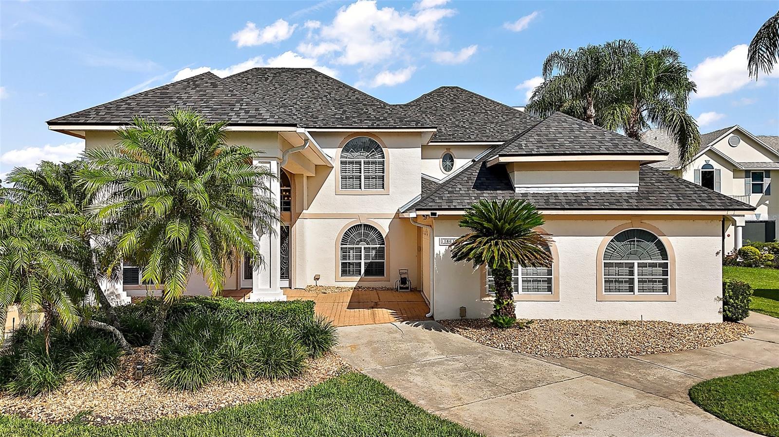 Lakefront home in the desirable Country Club of Mount Dora! BRAND NEW ROOF installed in July 2025! Nestled on a 1/2 acre lot on the serene shores of Lake Loch Leven, this beautiful custom built home boasts 4 spacious bedrooms, 3 full baths and 2 half baths! The massive gourmet kitchen offers abundant storage space with granite counters, huge island with bar area, SS appliances, double oven, walk-in pantry and a breakfast nook. The kitchen opens up to family room and is complete with a gas fireplace. The living room features a wet bar w/ granite counter top and the dining room provides plenty of space for family and friends. Bedrooms 3 and 4 are located downstairs and share a full bath including a garden tub and walk-in shower. Bedroom 4 is in the front of the home while bedroom 3 is located in the back and displays a beautiful lake view as well as a massive closet which can also be used as a storm shelter. The huge second bedroom is located upstairs and also exhibits incredible lake views in addition to a walk-in closet and large bathroom with walk-in shower. Also upstairs, you will be blown away as you enter the enormous master bedroom. Upon entering the master suite you'll love the "pre-master" with a sitting area, bay window with lake views and a mini wet bar! The 24x24 bedroom (not counting the pre-master space) provides access to the 12x15 deck/balcony with breathtaking lake views! The massive en suite master bathroom is centered by the large walk-in shower w/ 2 shower heads and his/hers sinks are located on either side. There is also a garden tub and his/hers walk-in closets. The expansive laundry room downstairs has lots of cabinets, a sink and a huge closet, while the oversized side entry two car garage is complete with workspace, a generator for downstairs and has golf cart access as well. Enjoy spending your summer days out by the screened in pool area complete with it's own pool bath, outdoor kitchen and storage closets, all with amazing lake views!! If that's not enough, the dock was replaced in 2024 and the Boathouse has a slip to accommodate a 24-foot boat. Unwind with direct lake access, perfect for boating, fishing or simply soaking in the scenery! Other upgrades include crown molding throughout the home, hurricane shutter for front door and window, plantation shutters and a central vacuum! This amazing community has an 18 hole golf course, pool and clubhouse, restaurant lounge and courts for pickleball and tennis! With a bit of updating this home has endless potential. This home is a rare gem, offering a lifestyle of relaxation and adventure. Don't miss your chance to come see this waterfront paradise before it's gone!