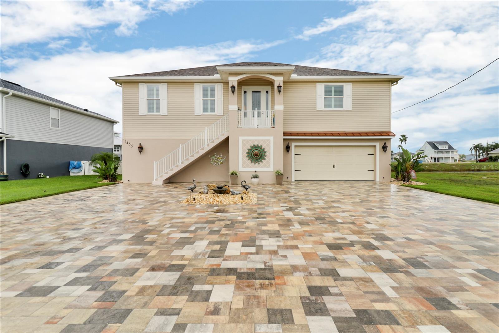 Welcome to your waterfront paradise! This custom-built home, constructed in 2019, is located in the desirable Hernando Beach South community. The upper level features nearly 2,200 square feet of thoughtfully designed living space with three bedrooms and two bathrooms.
The great room is an impressive focal point, featuring crown molding, a custom-built-in electric fireplace, and a 65-inch TV. Motorized shades give effortless control of natural light and privacy, while the 10-foot ceilings enhance the spacious feel. The kitchen is equipped with granite countertops, stainless steel appliances, and a large quartz island. The master suite is a true retreat with two walk-in closets and an en-suite bathroom featuring dual sinks, a garden tub, and a unique snail shower. The home is built with quality in mind, including double-hung vinyl impact windows and wood laminate and tile flooring throughout. The lower level provides almost 2,200 square feet of versatile, air-conditioned space with epoxy-finished floors. This area is perfect for a home gym, a game room with a pool table, or a large entertainment space. It also includes an oversized two-car garage, a bonus room, a full pool bathroom, and a large utility sink. Outside, a 12x26 inground pool equipped with a heater/cooler system is the centerpiece of the beautiful outdoor living space. The landscaping features decorative curbing, a stone fountain, and decorative rocks. The newly sealed brick paver driveway adds to the home's curb appeal, and a floating dock is ready for your boat.
