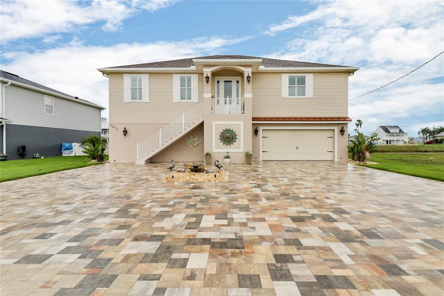 Welcome to your waterfront paradise! This custom-built home, constructed in 2019, is located in the desirable Hernando Beach South community. The upper level features nearly 2,200 square feet of thoughtfully designed living space with three bedrooms and two bathrooms.
The great room is an impressive focal point, featuring crown molding, a custom-built-in electric fireplace, and a 65-inch TV. Motorized shades give effortless control of natural light and privacy, while the 10-foot ceilings enhance the spacious feel. The kitchen is equipped with granite countertops, stainless steel appliances, and a large quartz island.  The master suite is a true retreat with two walk-in closets and an en-suite bathroom featuring dual sinks, a garden tub, and a unique snail shower. The home is built with quality in mind, including double-hung vinyl impact windows and wood laminate and tile flooring throughout.  The lower level provides almost 2,200 square feet of versatile, air-conditioned space with epoxy-finished floors. This area is perfect for a home gym, a game room with a pool table, or a large entertainment space. It also includes an oversized two-car garage, a bonus room, a full pool bathroom, and a large utility sink.  Outside, a 12x26 inground pool equipped with a heater/cooler system is the centerpiece of the beautiful outdoor living space. The landscaping features decorative curbing, a stone fountain, and decorative rocks. The newly sealed brick paver driveway adds to the home's curb appeal, and a floating dock is ready for your boat. (ADDITIONAL BUYER BENEFIT--Sellers are willing to entertain OWNER FINANCE OFFERS).
