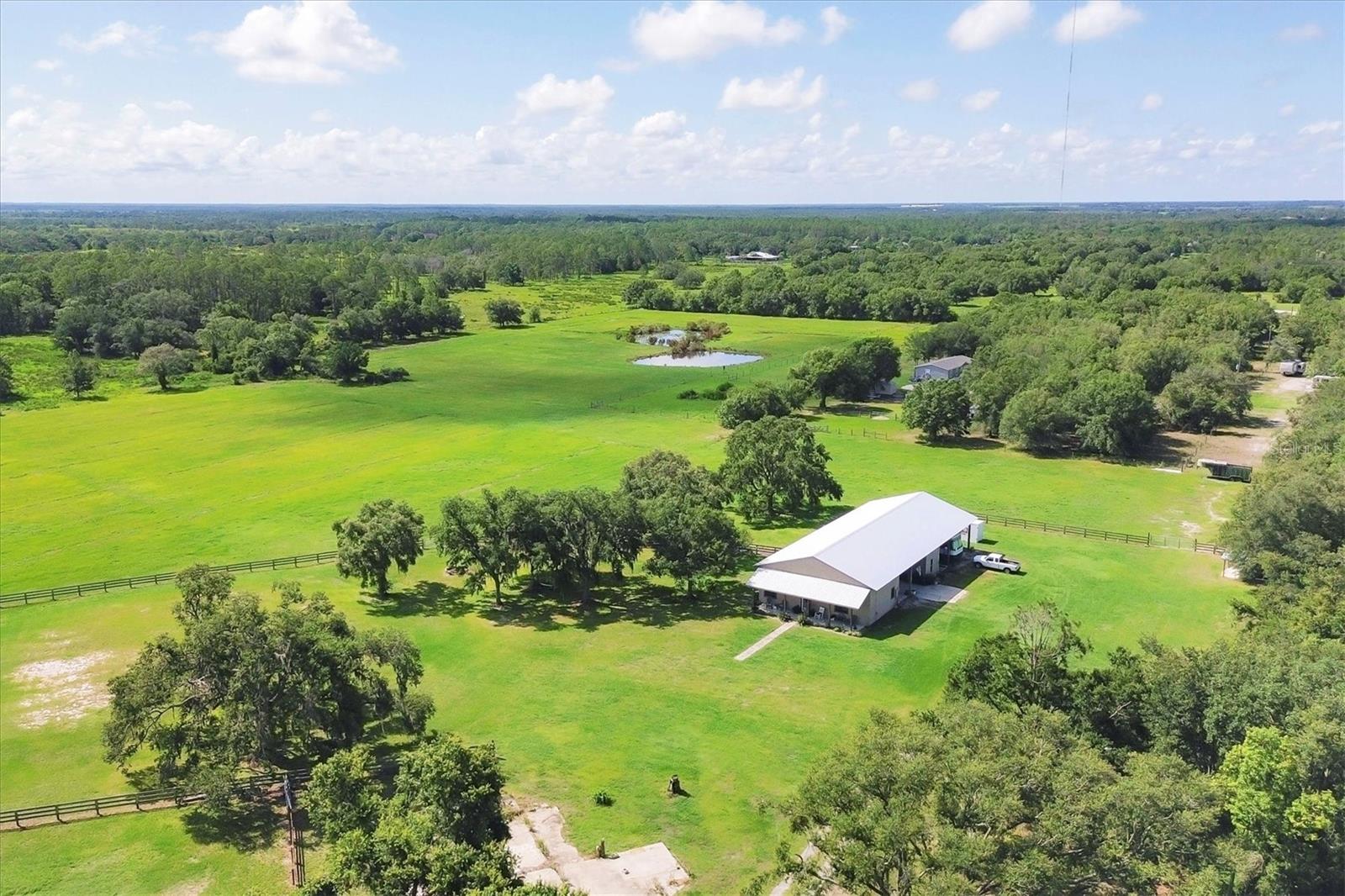 Private, 29.3 acre estate with 2br/1ba barn-dominium, fenced and cross fenced and ready for horses or cattle. Perfectly situated for family compound as it is currently plotted with 5 - 5 acre tracts with road access from 63rd or 65th. The barn-dominium is 40x100x14 total and includes a large workshop, RV parking/storage, RV hookup with septic access, 12x12 feed room or storage room, separate dog pens or additional storage space, and 200A power for running welder or other large machinery. All the prep work to build your dream home has been done and includes underground utilities, 8 inch well and house pad in place. Pastures seeded with Bahia and can be certified organic. The property is currently greenbelt exempt. While sitting on the front porch you will see an abundance of deer and turkey. There are no deed restrictions, and is considered high and dry with a mixture of A and X FEMA Flood Zones. Located off Verna Bethany Rd, just 13 miles from I75.