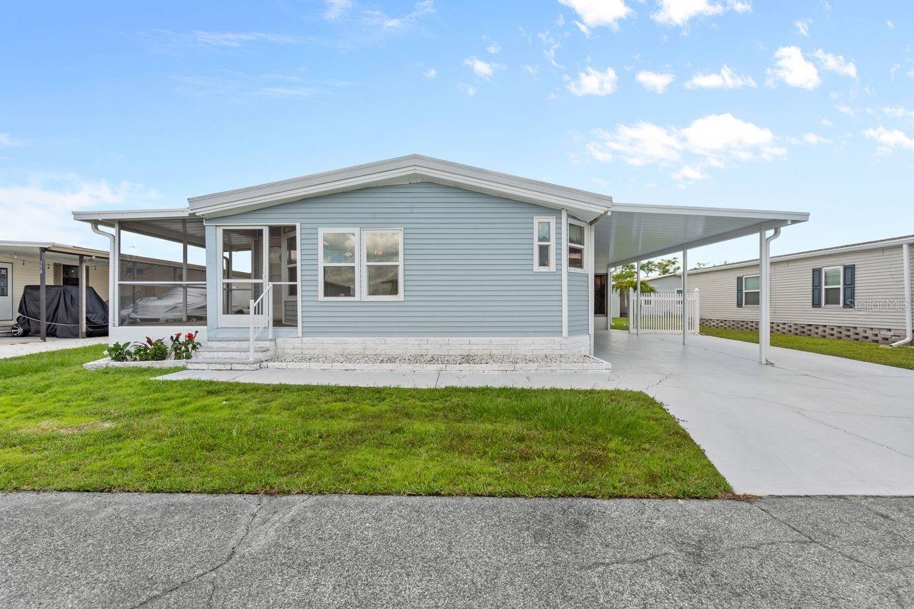 Motivated Sellers are offering this spacious SW Florida Getaway in a 55+ WATERFRONT COMMUNITY with GULF access! This affordable 2-bedroom, 2-bath home offers approx. 1,400 sq. ft. of bright, open living space in Harbor Cove where you can rent a BOAT SLIP for only $100 PER YEAR. This property features plentiful storage both inside and out, cathedral ceilings, a generous kitchen with room for all your kitchen gadgets and never-ending counter top prep space. Enjoy morning beverages in the bright breakfast nook adorned with windows and evening sunsets from one of your TWO screened and covered lanais. The open-concept living/dining area creates a welcoming space for entertaining plenty of guests. The huge primary suite has a walk-in closet and a large ensuite bathroom with garden tub and separate shower. There is a guest room near the hall bathroom and a separate room with a convenient built-in desk and interior washer/dryer hookups. Outside is an oversized driveway plus two storage areas. The vinyl siding was replaced and the roof was resealed in 2024 plus new AC in 2018. Harbor Cove is a boater’s paradise with a 90-slip marina and two-story activity center in which dances, bingo, card games, trivia, holiday parties, patio picnics and more are held. Residents enjoy two heated pools, a hot tub, tennis and pickle ball courts, shuffleboard, bocce, and a fitness center all for only $150 PER MONTH HOA fee. Partake in water aerobics, pool volleyball, art/craft classes, woodworking, and more. Boating and fishing opportunity are endless here and the community borders the beautiful Myakka River benefitting from the sights and sounds of nature and wildlife. Nearby are restaurants, retail shops, quality medical services, farmers’ markets, spring training baseball, area beaches and a short drive to I-75 for easy airport runs when guests come to visit. With some repairs and creative updates, this roomy home could be transformed into an incredible Florida retreat—offering tons of potential at a price that leaves room to make it your own. Schedule a private showing today!