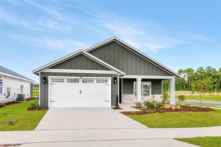 Pre-Construction. To be built. Set in Tanglewood in Newberry, FL, The Clover by William Weseman Construction puts you in the middle of what makes this part of Alachua County so appealing: the small-town charm of Newberry and the conveniences of Jonesville and Gainesville. Built by a 3rd-generation local builder, this new construction home blends practical design, durable materials, and polished finishes. This 4-bedroom, 3-bath plan offers 1,891 heated and cooled sq ft with a true 3-way split-bedroom layout designed for comfort and flexibility. The main living area centers around an open great room where the kitchen, dining, and living areas flow together to create a bright central gathering space. The kitchen is anchored by a huge center island and includes quartz countertops, solid wood cabinets with soft-close drawers, tile backsplash, pull-out dual trash bins, and a stainless steel under-mount single-basin sink. A corner pantry and abundant cabinetry provide excellent storage, and included appliances are a stainless steel slide-in electric range, microwave, and dishwasher. The primary suite is located at the rear of the home and features a triple window, spacious walk-in closet, and bathroom with dual sinks, a full tile shower, and a private water closet. Two additional bedrooms and a full bathroom with tub are located in a separate wing of the home, while the fourth bedroom includes its own full bathroom and walk-in closet. This setup works well as a guest suite, teenager retreat, or flexible space for multigenerational living. The laundry room includes a utility sink. Step outside through the 8'x8' glass slider to the rear porch, extending the living space outdoors. Additional interior highlights include LVP flooring throughout, ceramic tile in bathrooms, 9' ceilings, recessed LED lighting, and ceiling fans. Exterior details include stacked stone accents, Hardie board siding with spacer clips and board-and-batten accents, 12"x12" columns, low-maintenance aluminum soffits, a fully sodded Zoysia yard, and a 2-car garage with an 8' door. Energy-smart features include Low-E windows, R-30 insulation, 15 SEER HVAC, electric water heater, and wi-fi enabled thermostat and garage door opener. Buying at this stage offers buyer design selections and personalization, with choices and upgrades available including roof shingle color, exterior paint color, stone accent color, cabinet color, countertops, interior paint color, front door, and interior door style. Tanglewood’s planned amenities include a pool, playground, pickleball, covered pavilion, and sidewalks on both sides of the street. The $95/month HOA includes access to future amenities plus front yard mowing and maintenance. Community services include Clay Electric, the City of Newberry, and Cox Cable. Zoned for Newberry Elementary, Oak View Middle, and Newberry High School (buyers should verify school zoning). The location offers convenient access to daily essentials and area destinations: 2.5 miles to Publix, 5 miles to area schools, 5 miles to Tioga Town Center, 6.5 miles to Jonesville Park, 4.9 miles to Easton Sports Complex, 8 miles to Diamond Sports Park, 9 miles to I-75, 13 miles to UF, 9.3 miles to HCA Florida North Florida Hospital, and 15 miles to the VA Hospital and UF Shands Hospital. Estimated completion: June 2026. Lot 6 is a 55' x 120' homesite. Photos are of a previously completed similar home; finishes and selections may vary. Ask us for availability, construction updates, and current selections list.
