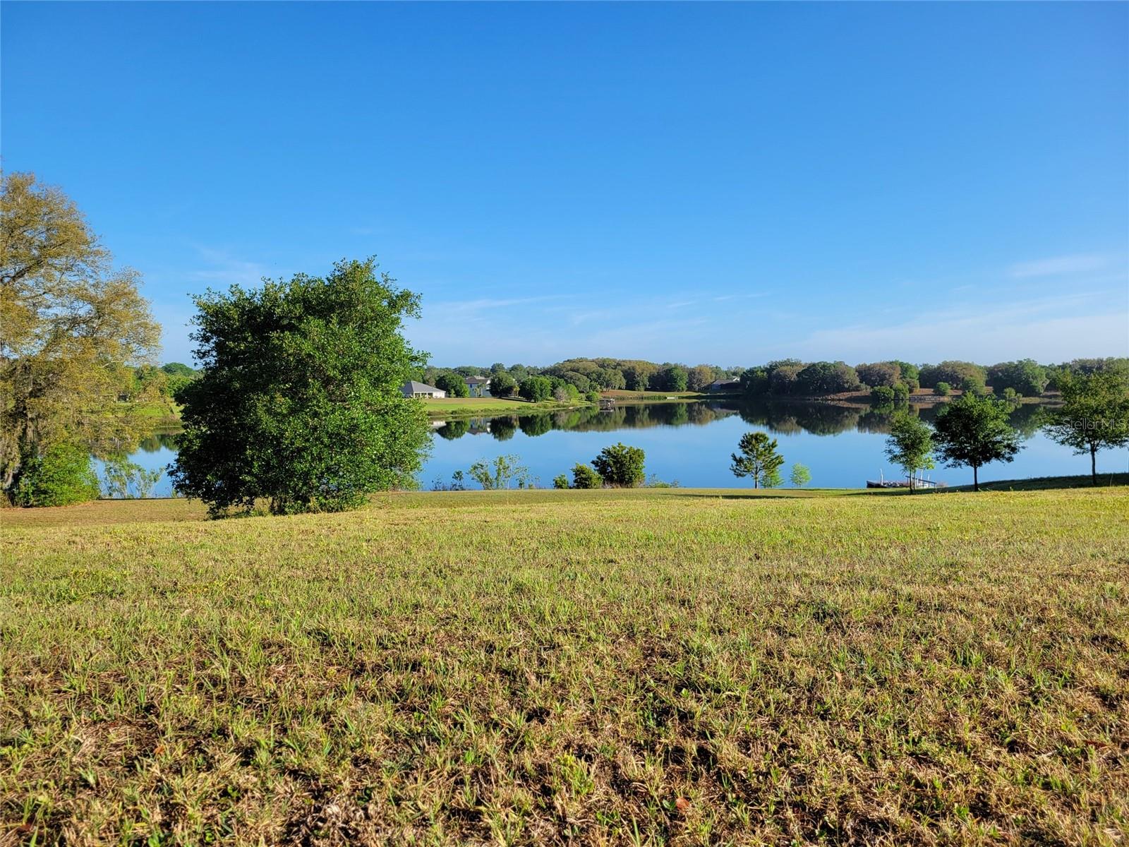 Don’t miss your opportunity to build your Dream home! This exceptional oversized lot provides the perfect foundation to bring your dream home to life—whether you envision a hillside walkout basement or a single- or two-story design with stunning lake views. Located in the prestigious Black Bear Reserve of Lake County, FL, this property combines the tranquility of country living with upscale amenities. Set within a community featuring a P.B. Dye-designed golf course, it offers a perfect balance of relaxation and recreation. Prime Location: Only 15 minutes from the charming town of Mount Dora, known for its boutique shops and cozy cafés. A short drive to downtown Eustis, where you’ll find waterfront dining, unique shopping, and entertainment—including one of Florida’s last remaining historic bandshells.
Less than an hour from the pristine beaches of Daytona, Ormond, and New Smyrna. Just 30 miles from Orlando’s world-famous attractions, including Walt Disney World. Community Perks: Play golf every day on an exceptional course, with optional membership upgrades for an enhanced experience. Enjoy delicious meals at Bear’s Den, the onsite restaurant serving breakfast, lunch, and dinner.
Additional amenities include a playground, tennis and pickleball courts, and a community dock for lakeside relaxation.
Peace of Mind: This stunning waterfront lot is not only picturesque but also free from flood insurance requirements, as confirmed by FEMA documentation and survey reports. Don’t miss this rare chance to claim your piece of paradise in Black Bear Reserve—where you can build the home and lifestyle you’ve always imagined!