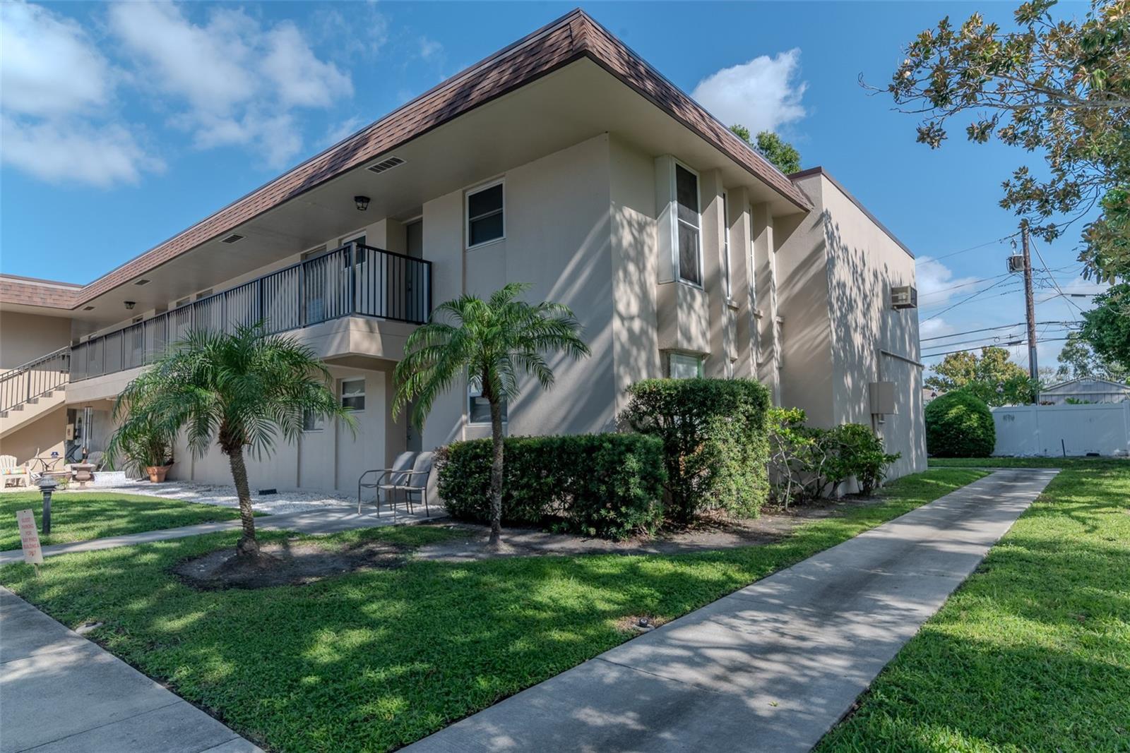 Amazing value! Close to the Beach! Sought after 2 bed, 2 bath end/corner unit with 3 additional windows facing east and lots more light than inside units in the building. In addition, the end unit gives more privacy and peace with one less neighbor on one side plus this residence is on the top floor so no neighbors walking above you! Can be sold including furniture. Building has elevator. Parking is easy with 1 car assigned carport included right in front of the unit.This condo has over 1,100 sq ft with a huge, back sunroom (30' X 7') with tons of light and laundry room with lots of storage. Primary bedroom has large walk-in closet and ensuite full bathroom with walk-in stall shower. Good amount of closet and storage inside the unit with an additional secured, storage space on 1st floor of building. Ample guest parking. 2 miles to the beach, less than 6 minute drive or 14 minute bike ride! Owner loves to walk a block to the beautiful lake with pathways to watch all the prettyl birds. This 55+ community offers lots of amenities. Condo fee includes elevator, water, sewer, trash, cable tv, internet, heated pool, fitness center, shuffleboard, library, clubhouse with lots of activities and also lawn maintenance. Conveniently located across from St Petersburg Bay Pines VA Healthcare system and Hospital. Shopping is close by for Walmart, Dunkin' Donuts, Starbucks and Wawa. Close to the amazing Pinellas Trail just a few blocks away for all your riding, running and walking pleasure! Become part of this great community.