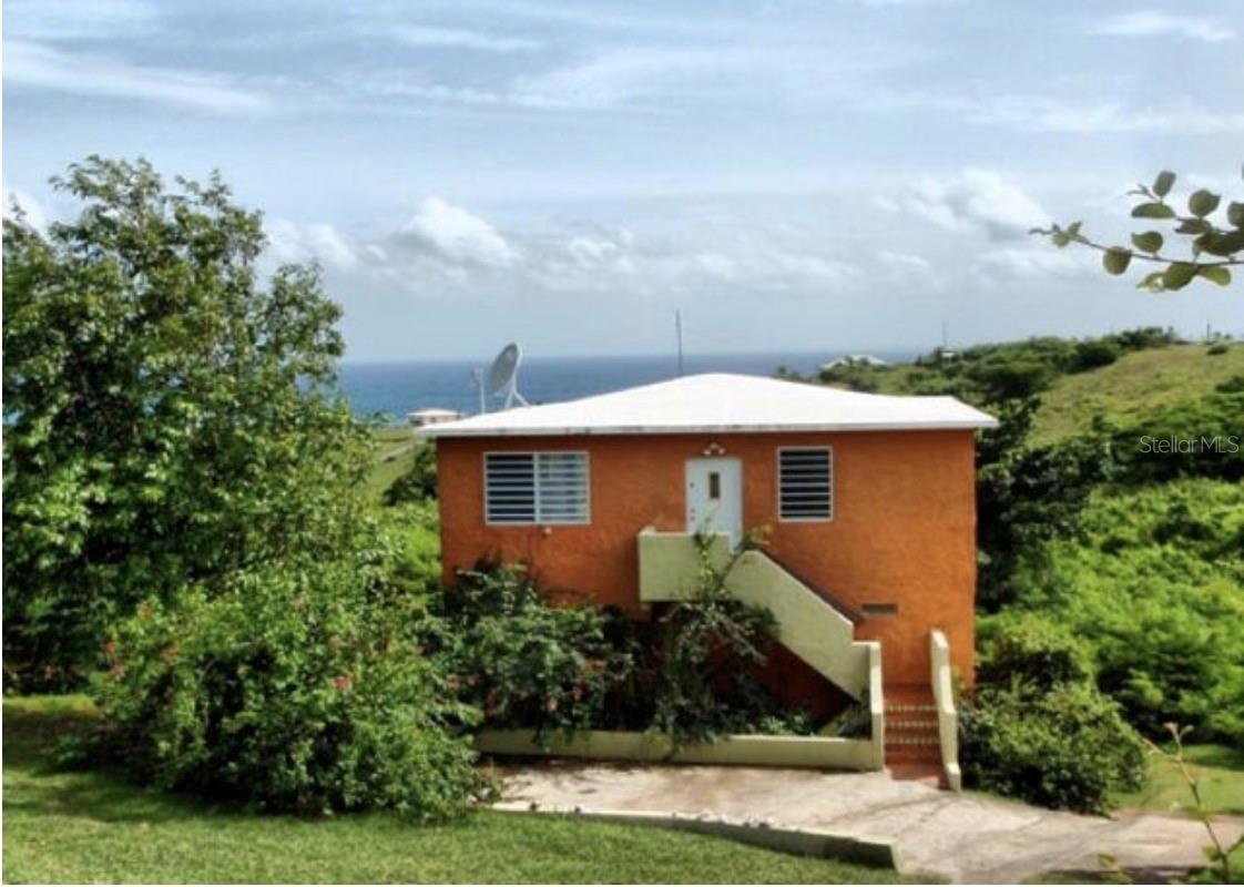 Casa Mamey is a two story, 3 bedroom/3 bathroom home located in unspoiled Villa Boriquen with its lush vegetation, rolling hills, and spectacular views. From Casa Mamey you can see the islands of Puerto Rico, Culebra & St Thomas resting like jewels in the lush blues and greens of the Atlantic ocean. Casa Mamey sits proudly in a sumptuous & private ravine and is surrounded by rich undergrowth increasingly bearing tropical fruits and flowers.
Outside, the large and comfortable deck offers constant ocean breezes and an ever-changing view. Watch the horses roam the country side with your morning coffee in hand; count the stars with late night cocktails!
At Casa Mamey, everything you need is close by: Shopping in Isabell II, A stroll on the Malecon (boardwalk) in Esperanza, Fruits and vegetables and fresh fish at local markets, All are minutes from what could be your new, fully furnished, home base…
Punta Arenas beach. La Chiva and Caracas beach. Sea Glass beach. Sun Bay. The list of spectacular Vieques beaches goes on and on… Or, explore, and discover your own special beach. From Casa Mamey, you can walk to Bastimento Beach in 15 minutes. It is the ONLY beach gateway to Fish & Wildlife land that stretches MILES toward the rising sun. All other island beaches are with-in a 5 to 25 minute drive!