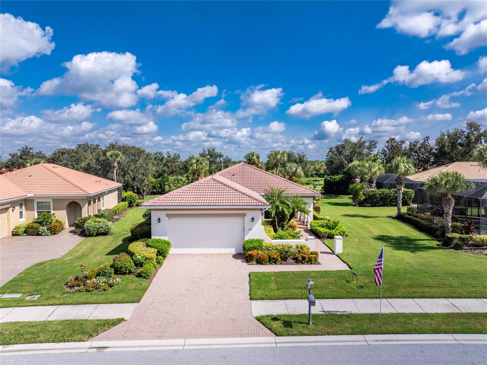 Welcome to this WCI-built Grand Villa Lesina model, a stunning property boasting 1,756 sq ft of open and airy living space, perfectly situated in a maintenance-free section of the prestigious, gated golfing community of the Venetian Golf & River Club. The home features a large great room with tray ceilings, opening to a spacious kitchen equipped with stainless steel appliances, granite countertops, a breakfast bar, and a built-in cafe-style dining area. The kitchen also includes a convenient closet pantry and tile flooring. This charming villa offers two comfortable bedrooms, including a luxurious owner's suite with tray ceilings, a full bath featuring a garden tub, a separate glass shower, dual sinks with Corian counters, a private water closet, and a walk-in closet. For additional flexibility, a bonus room with a double-door entry is located just off the kitchen, perfect for a den, study, or formal dining room. The side entry adds to the home's curb appeal with lovely landscaping. Hurricane impact windows. Inside, a spacious foyer includes an extra closet, and the two-car garage provides ample storage. Finally, a screened lanai offers a perfect spot to relax and enjoy the lovely views. This home truly blends comfort and style, making it an ideal retreat.