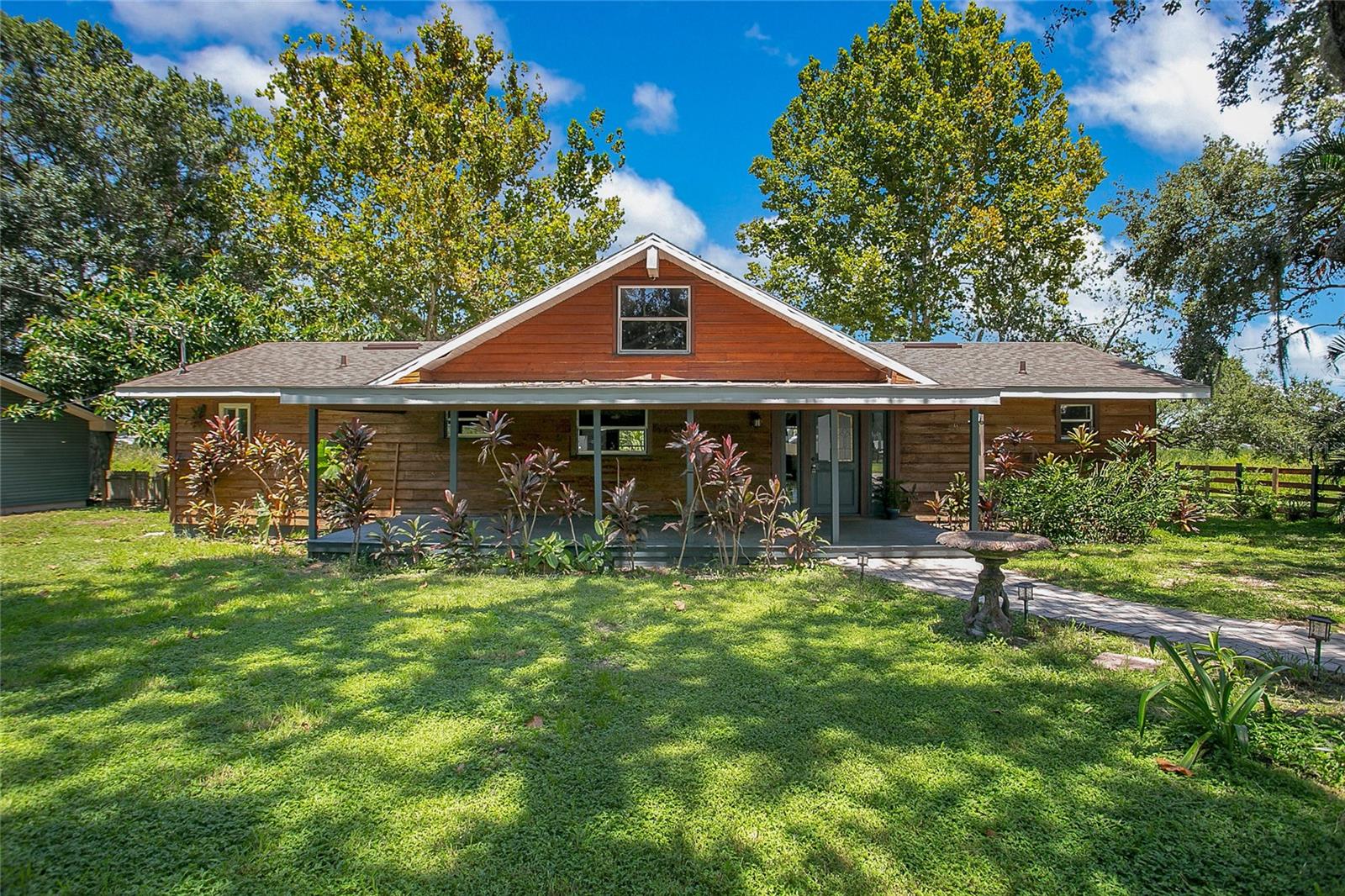 Lakefront living on nearly 2 acres! This 3 bedroom, 3 bath home sits on 1.74 acres along the private shores of Lake Fox. Offering over 2,100 sq ft of living space, the property features spacious common areas, vaulted ceilings, and large windows with serene lake views. The split floor plan includes a generous primary suite, two additional bedrooms, and multiple living and dining spaces. Outside, enjoy mature trees, a peaceful setting, and direct access to the water. With a newer roof (under 3 years old) and no HOA restrictions, this property provides the perfect opportunity to update or customize to your vision. Conveniently located near shopping, dining, and major roadways, this lakefront home offers privacy and potential in the heart of Winter Haven.