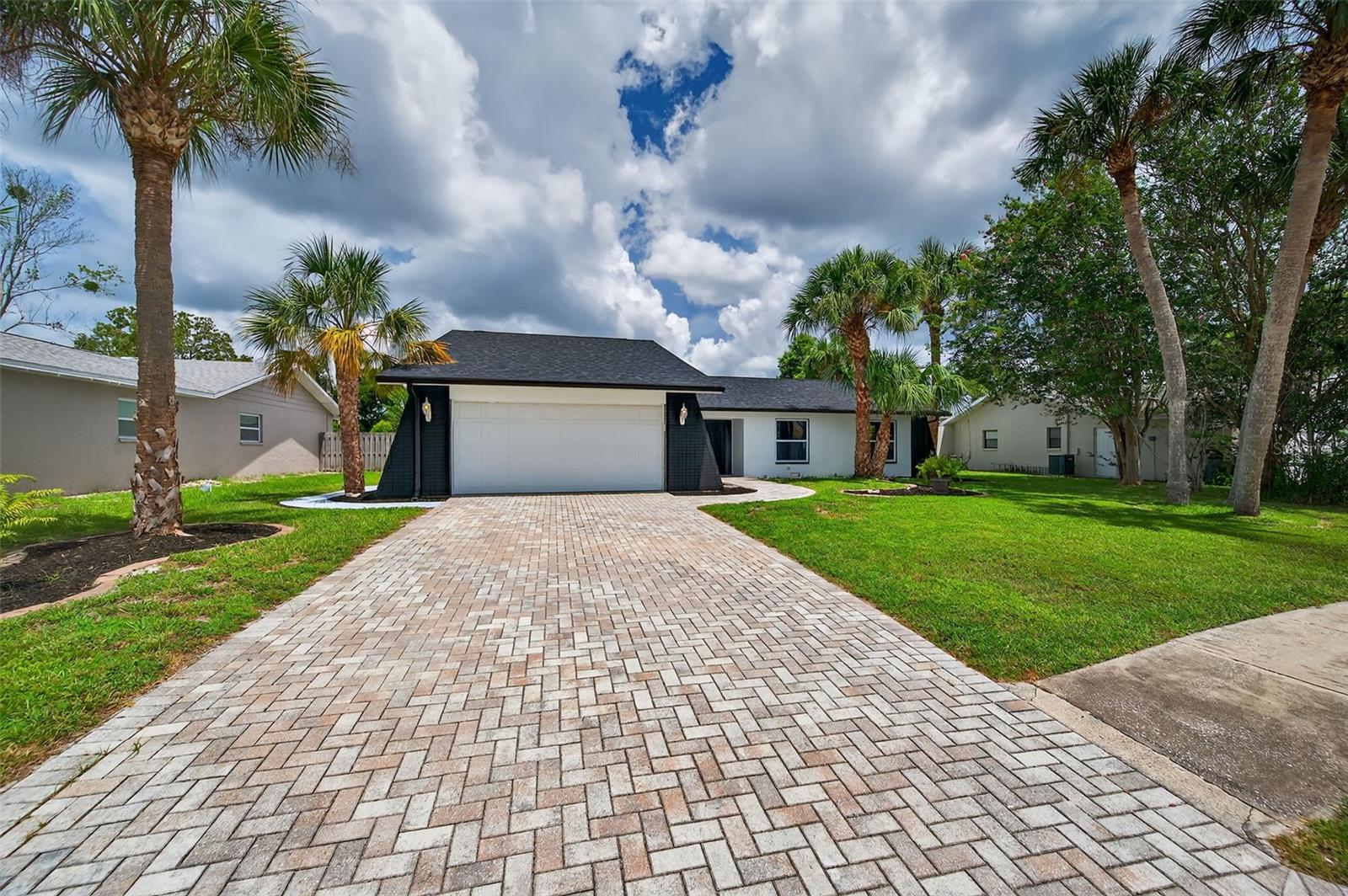 You could keep looking, or you could take a closer look at perfection. Step inside this beautifully updated home, offering over 2,000 sq ft of living space. The GOURMET KITCHEN is a standout, featuring GRANITE COUNTERTOPS, STAINLESS STEEL APPLIANCES, and a stylish BACKSPLASH, complemented by a DEEP DOUBLE UNDERMOUNT STAINLESS STEEL SINK for both functionality and elegance. Natural light pours in through MULTIPLE DOUBLE-PANE, LOW-E WINDOWS, which open inward for easy breezy cleaning. The open concept continues into the living areas, where you'll find a cozy WOOD-BURNING FIREPLACE, perfect for relaxing evenings. The home also boasts AMPLE CLOSET SPACE for all your storage needs. Moving through the home, you'll find 3 SPACIOUS BEDROOMS and 2.5 MODERN BATHROOMS, with plenty of room to create a fourth room if desired. Additional features include ALL NEW LIGHTS AND CEILING FANS throughout, enhancing the bright and modern feel. You’ll also find a BRAND-NEW ELECTRICAL PANEL, BRAND NEW 3-DIMENSIONAL ROOF (February 2025), and a NEW WATER HEATER (2025), ensuring peace of mind for years to come. Step outside to the HUGE LANAI and SPARKLING POOL, perfect for year-round outdoor entertainment. The property sits in a NO FLOOD ZONE and has NO CDD, providing added security and comfort. Located in an IDEAL LOCATION near schools, beaches, medical plazas, shopping centers, restaurants, places of worship, the airport, and tourist attractions – everything you need is within easy reach. This home truly has it all, inside and out. Don’t miss the opportunity to make it yours!