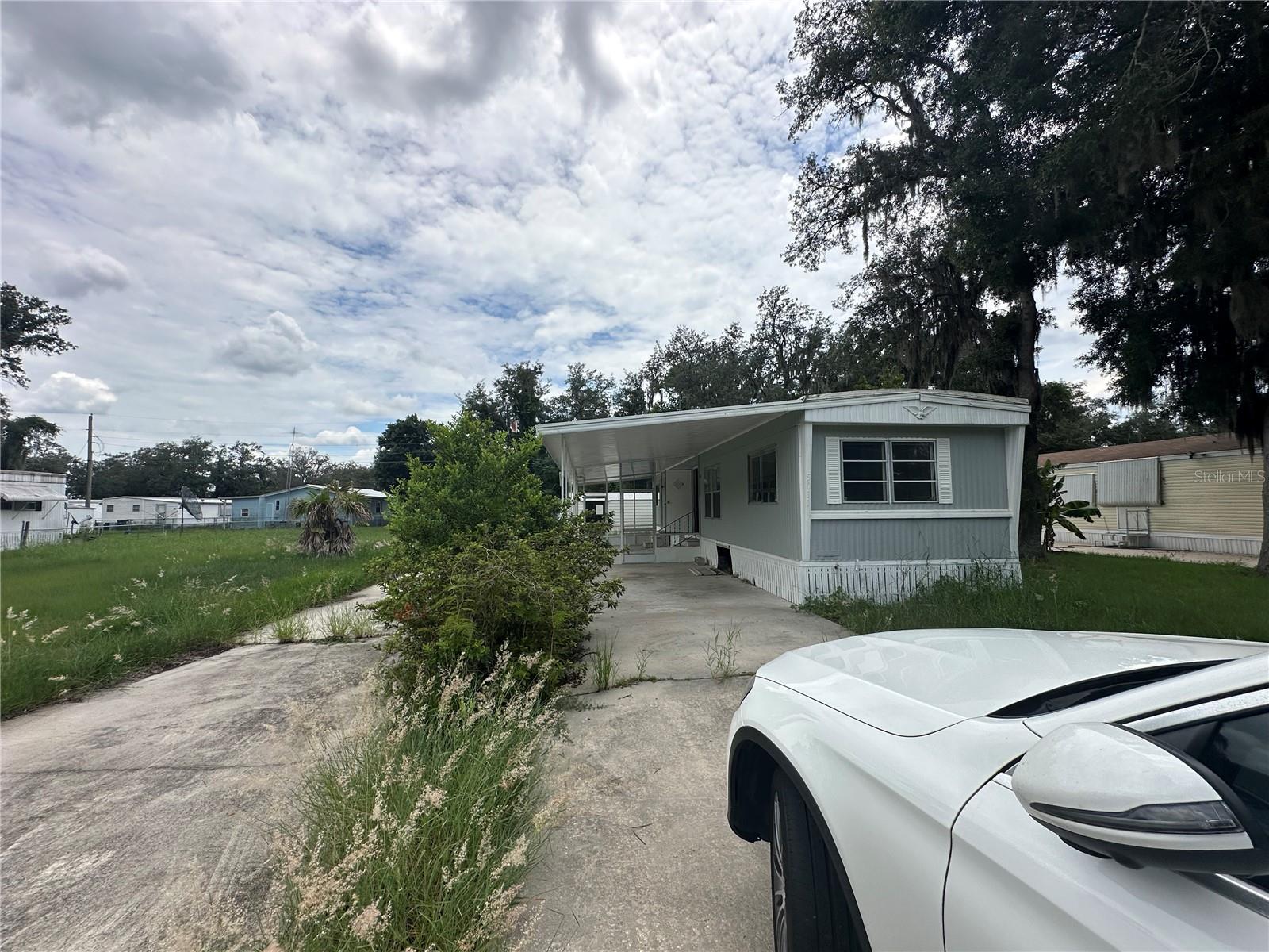 Mobile Home with NO HOA and Land Included!!!! 2 bedroom, 2 bathroom home with Carport and Lanai.. Needs a little TLC, handyman or DIY special. Property has 3 large sheds equipped with electric! Property boasts .17 acre of land in beautiful Sebring, minutes from HWY 27 and Lake Jackson. Shopping, Schools, commerce all within minutes.